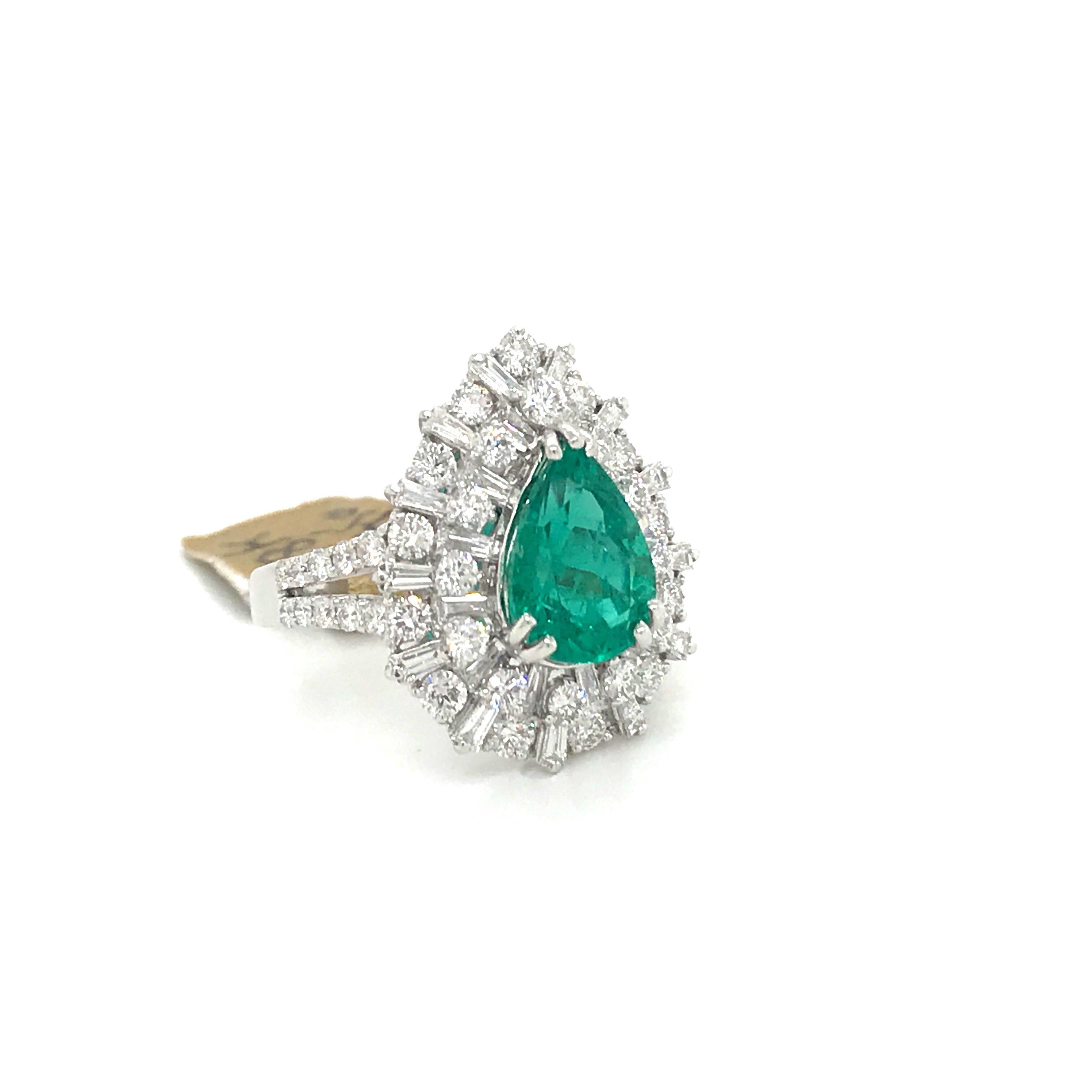 18K White gold cocktail ring featuring one pear shape emerald weighing 2.65 carats flanked with baguette and round brilliants weighing 2.00 carats.
Origin: Brazilian
Not Treated 
Color G
Clarity VS-SI