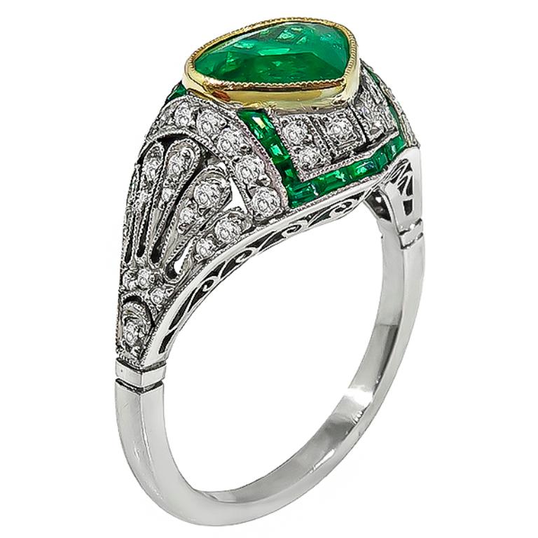 This gorgeous platinum ring is centered with a lovely pear shape emerald that weighs approximately 1.50ct. The center stone is accentuated by sparkling round cut diamonds that weigh approximately 0.50ct. graded H color with VS clarity.
It is