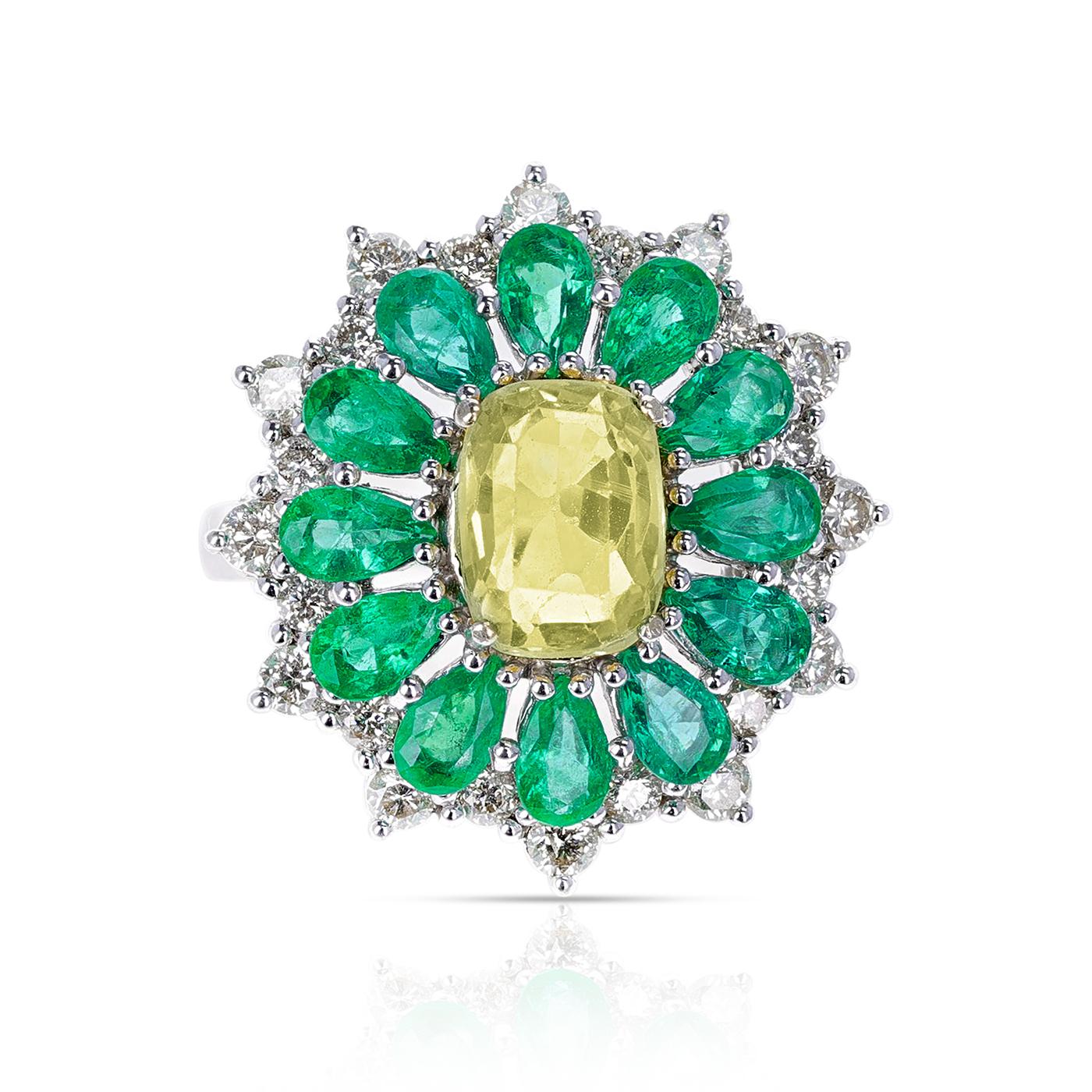 A stunning ring with Pear-Shape Emeralds, Round Diamonds and a Center Oval Cushion Yellow Sapphire, made in 18K White Gold. The yellow sapphires weigh appx. 2.74 carts. Ring Size US 8. Total weight: 8.80 grams. 