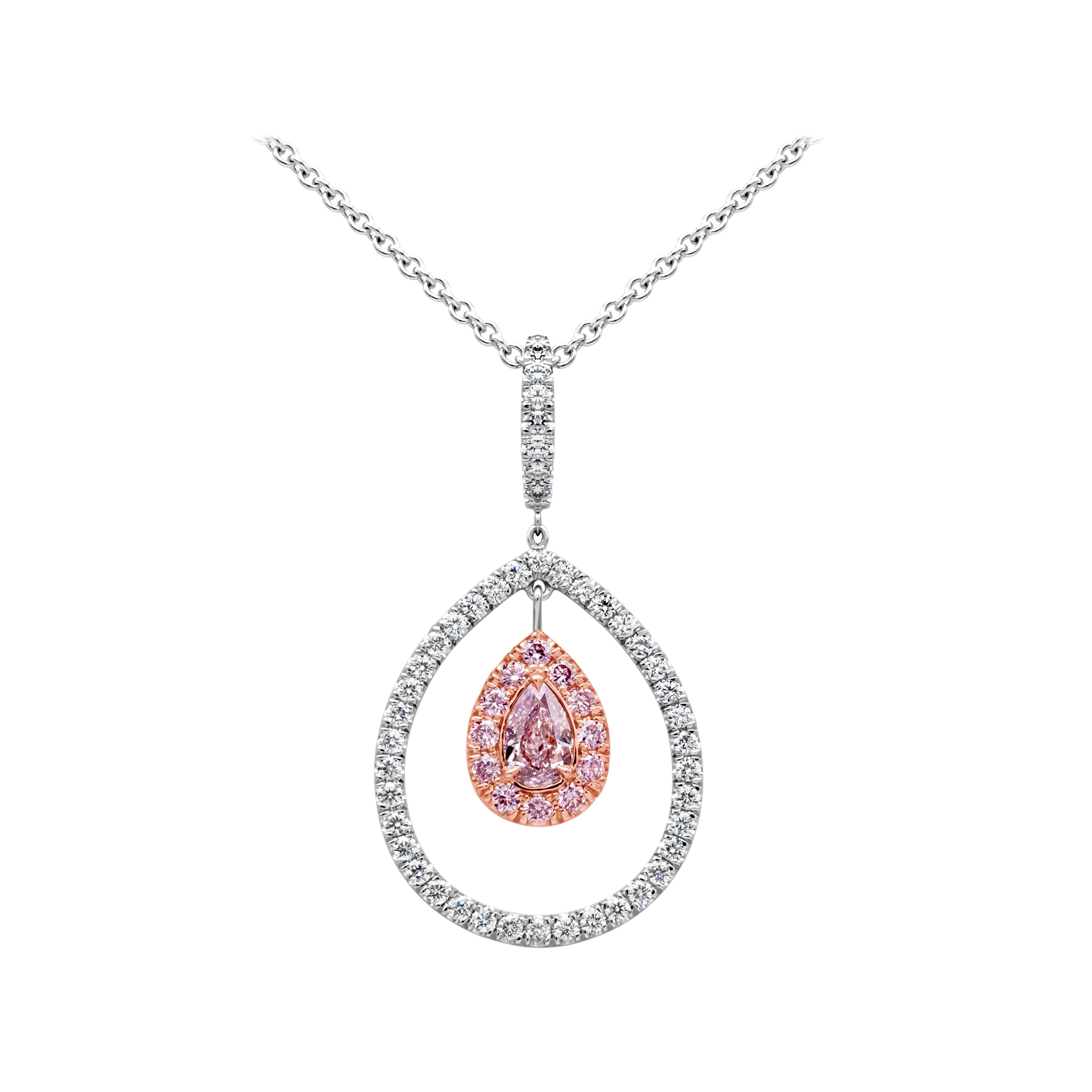 A beautiful pendant necklace showcasing a 0.30 carats pear shape fancy purple pink diamond certified by GIA as fancy purple pink color and VS2 in clarity. Center diamond is surrounded by two rows of matching pink diamonds weighing 0.17 carats total