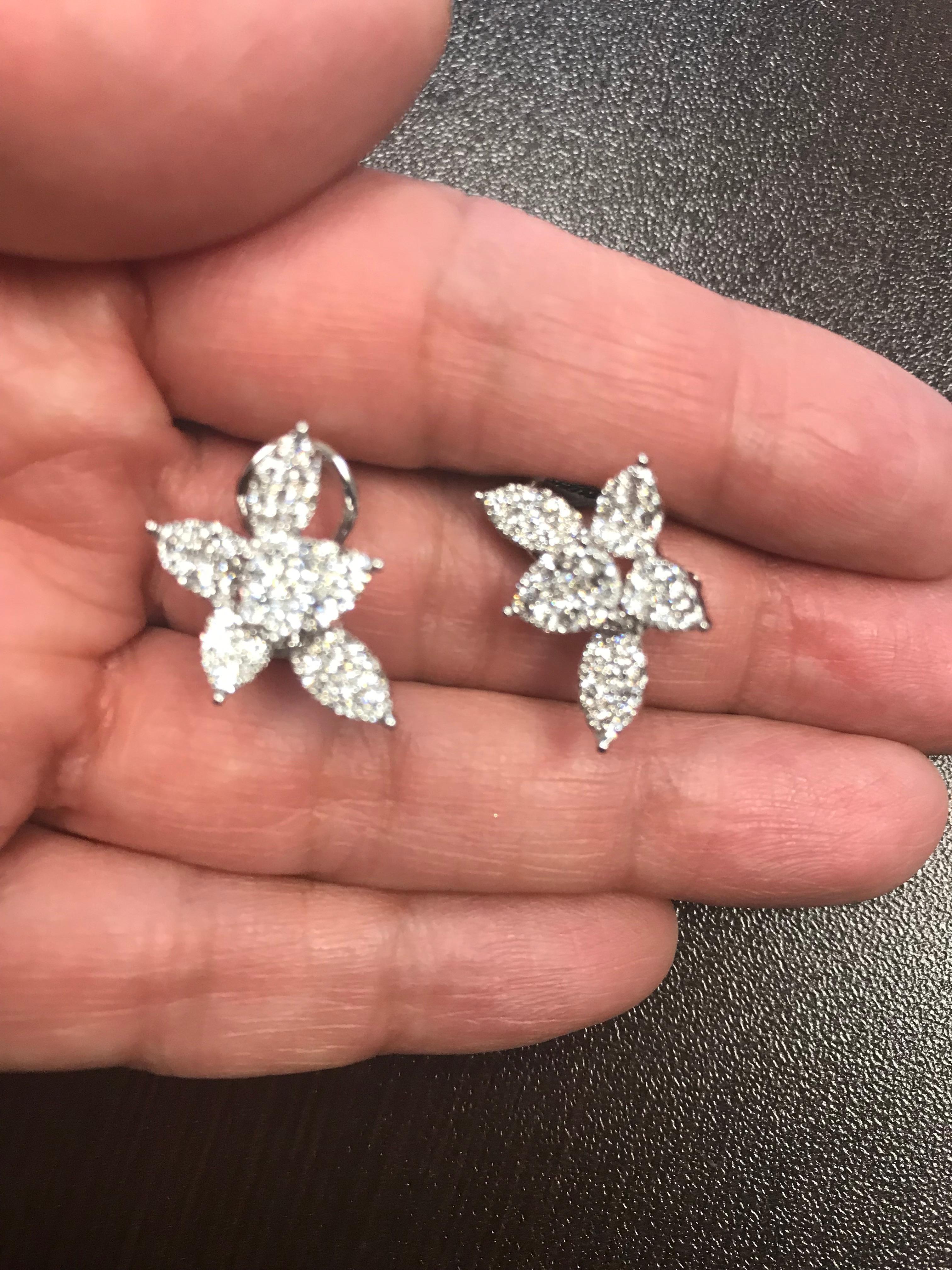 This pear shaped flower earrings are set in 18K white gold. The earrings are set with round diamonds. The total carat weight is 1.84. The color of the stones are F, the clarity is VS1-VS2. These earrings are set in a pave style, that create the