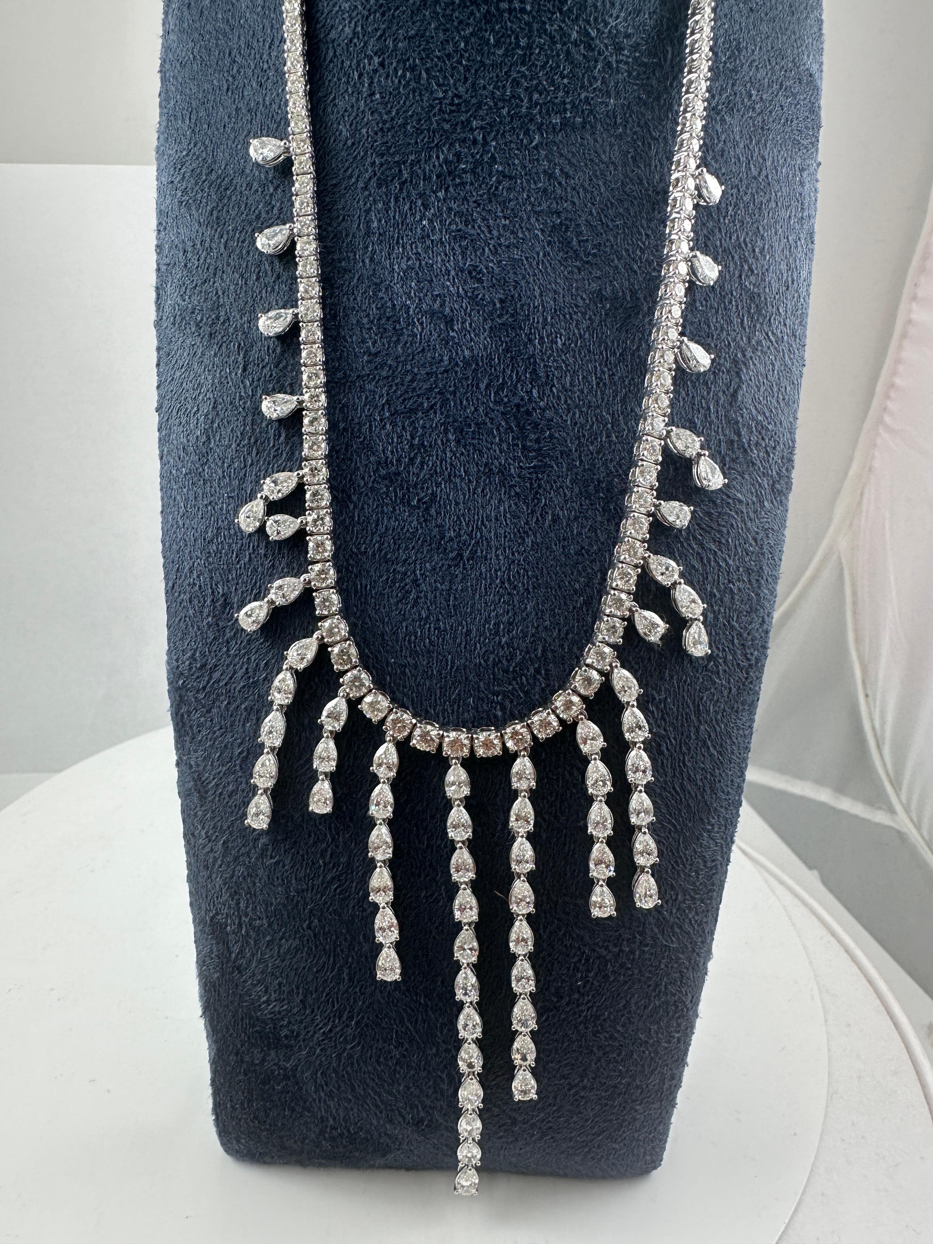Bold, brilliant, and immaculately designed, this showstopping fringe diamond necklace showcases a dazzling cascade of pear-shaped and round brilliant diamonds, masterfully set in fine 18K white gold. With a total carat weight of 22.60 carats, this