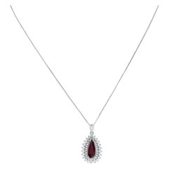 Pear shape Garnet pendant surrounded by diamonds set in 18K white gold, w/ 16"