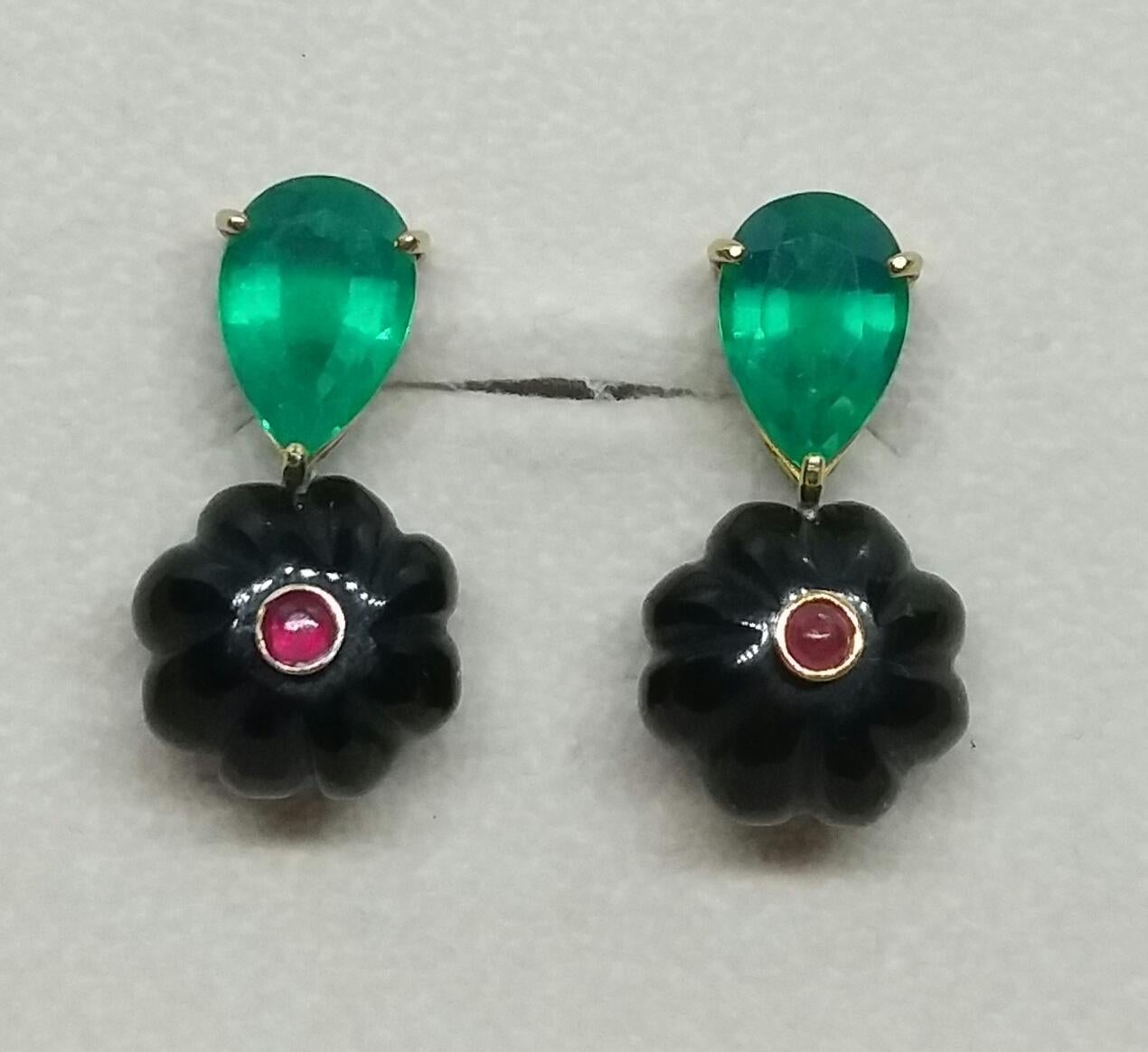 
Simple chic stud earrings with a pair of faceted pear shape Green Quartz on the top and 2  Black Onix flat round carved beads of 15 mm in diameter with in the center 2 small round Ruby Cabs set in yellow gold 

In 1978 our workshop started in Italy