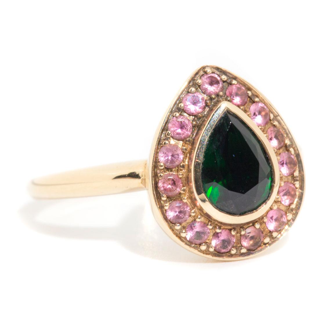 Forged in 9 carat yellow gold, this charming contemporary ring is embellished with an elegant display of green and pink tourmalines, with the central pear-shaped tourmaline exhibiting an alluring deep green hue and the surrounding pink tourmalines