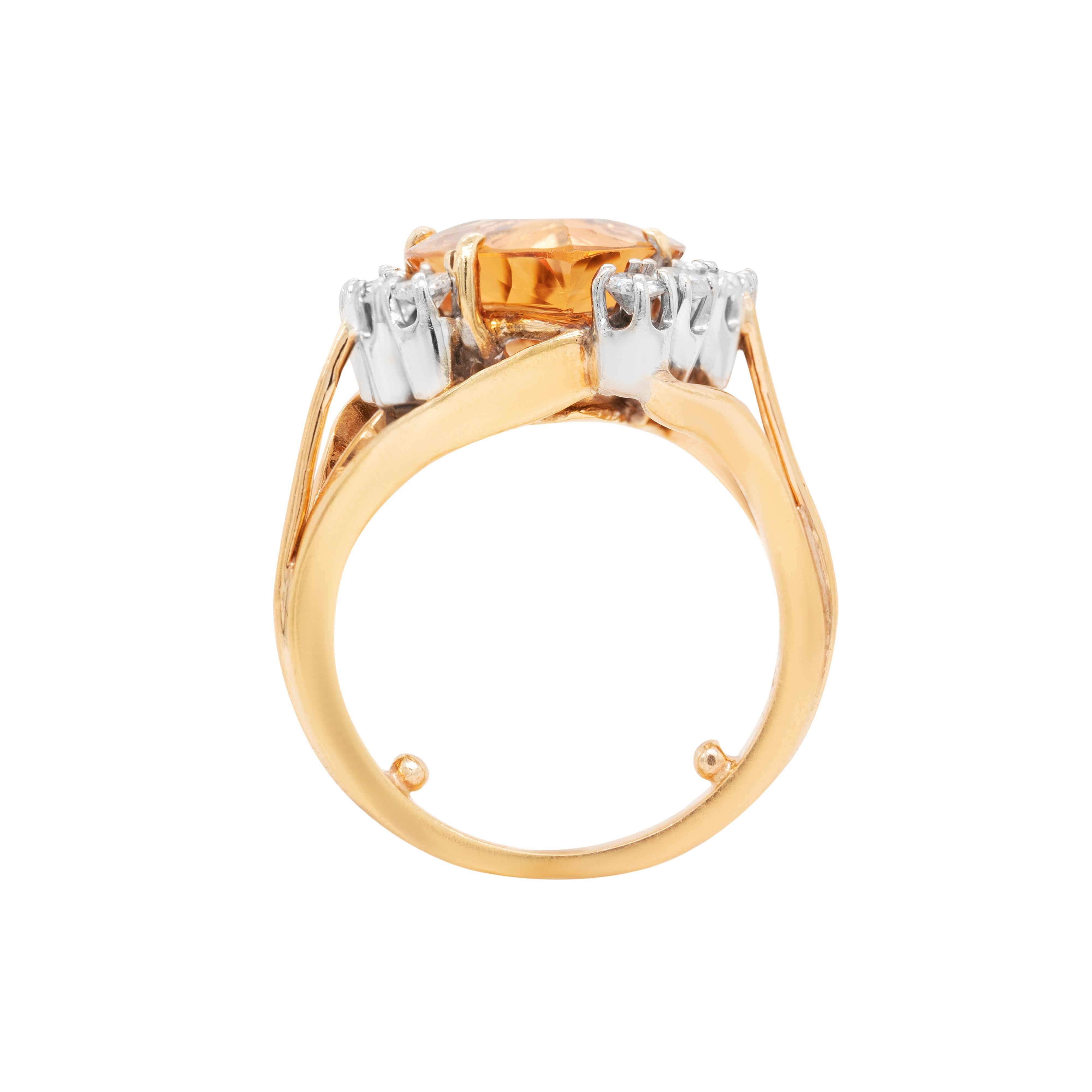 This wonderful 18 carat yellow gold cocktail ring features a spectacular pear shaped golden imperial topaz weighing 7.82ct, mounted in a four claw, open back setting. The incredible stone is decorated with 10 fine quality round brilliant cut