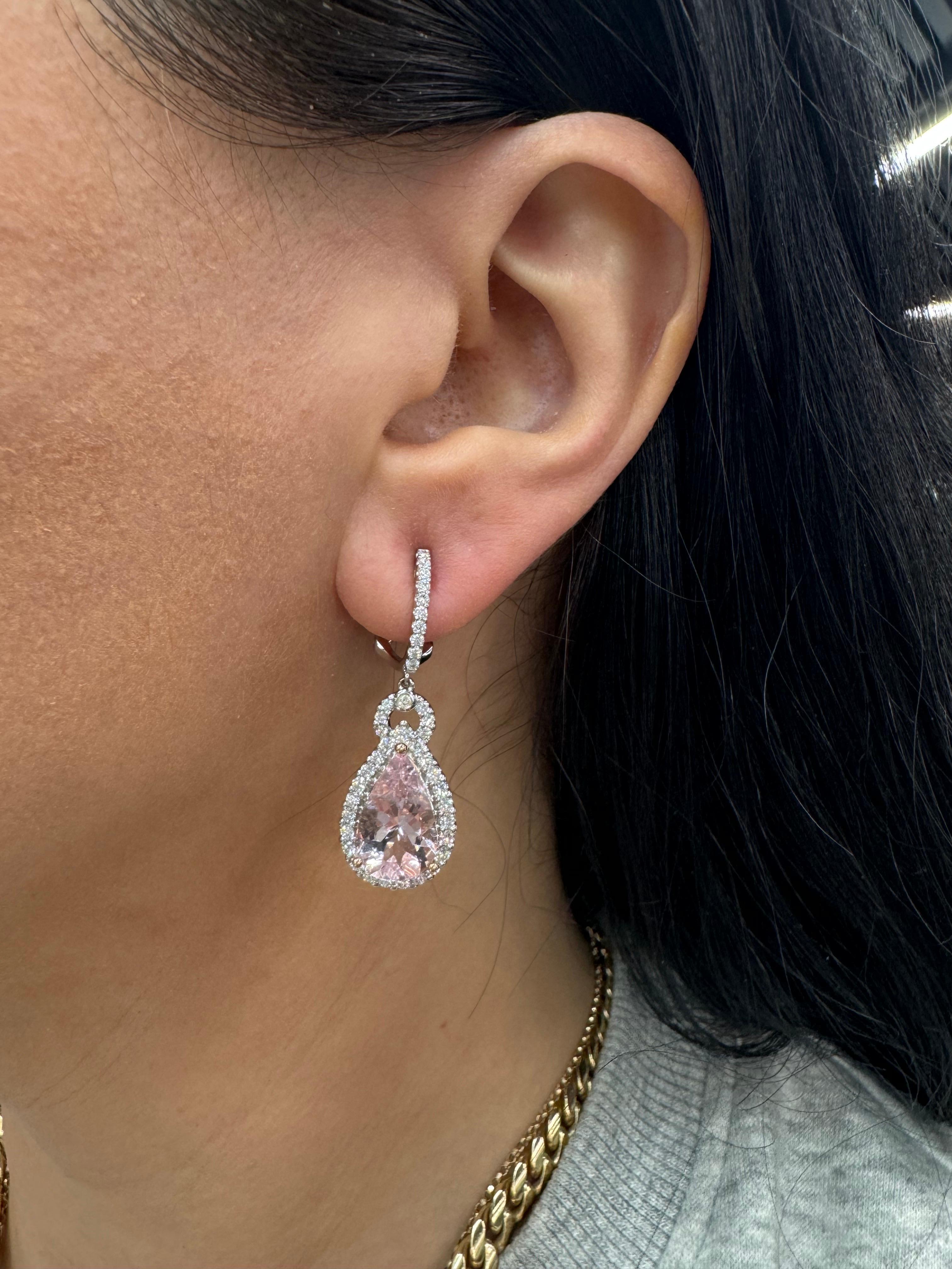 Pear shape Morganite drop earrings weighing 7.38 carats flanked with round brilliants weighing 1.30 carats, in 18 karat white gold. 
Matching pendant available