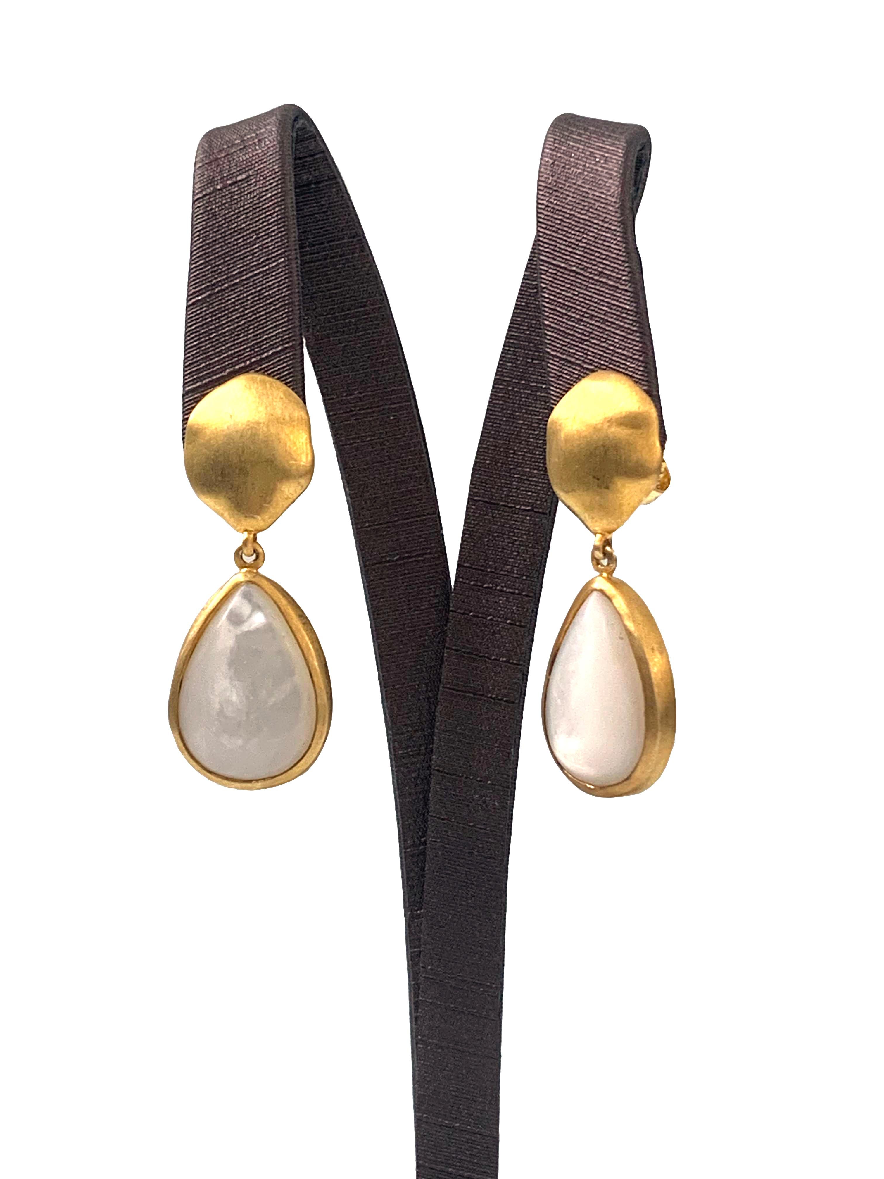 Discover pear-shape Mother of Pearl vermeil drop earrings. The earrings feature 2 large pear-shape cabochon-cut Mother of Pearl with unique and beautiful luster, handcrafted brushed satin texturing technique, and hand set in vermeil 18k gold plated
