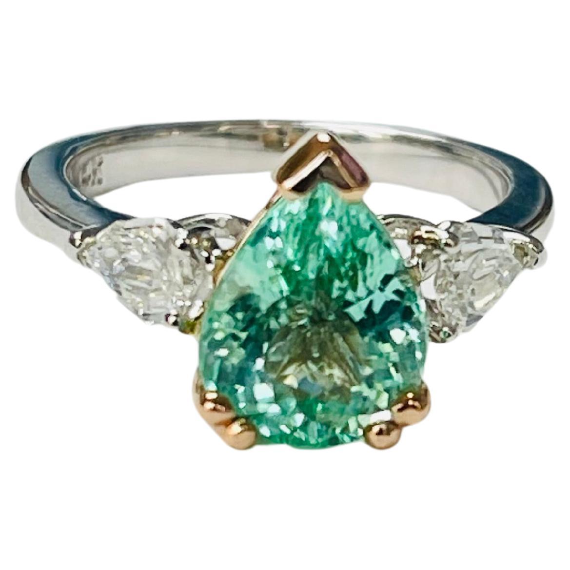Pear Shape Paraiba Tourmaline and Diamond Engagement Ring beautifully handcrafted in 14 Karat white gold. 

The details are as follows : 

Pear Shape Paraiba Tourmaline weight : 2.59  carat 
Diamond weight : 0.57 carat ( G color and VS clarity )