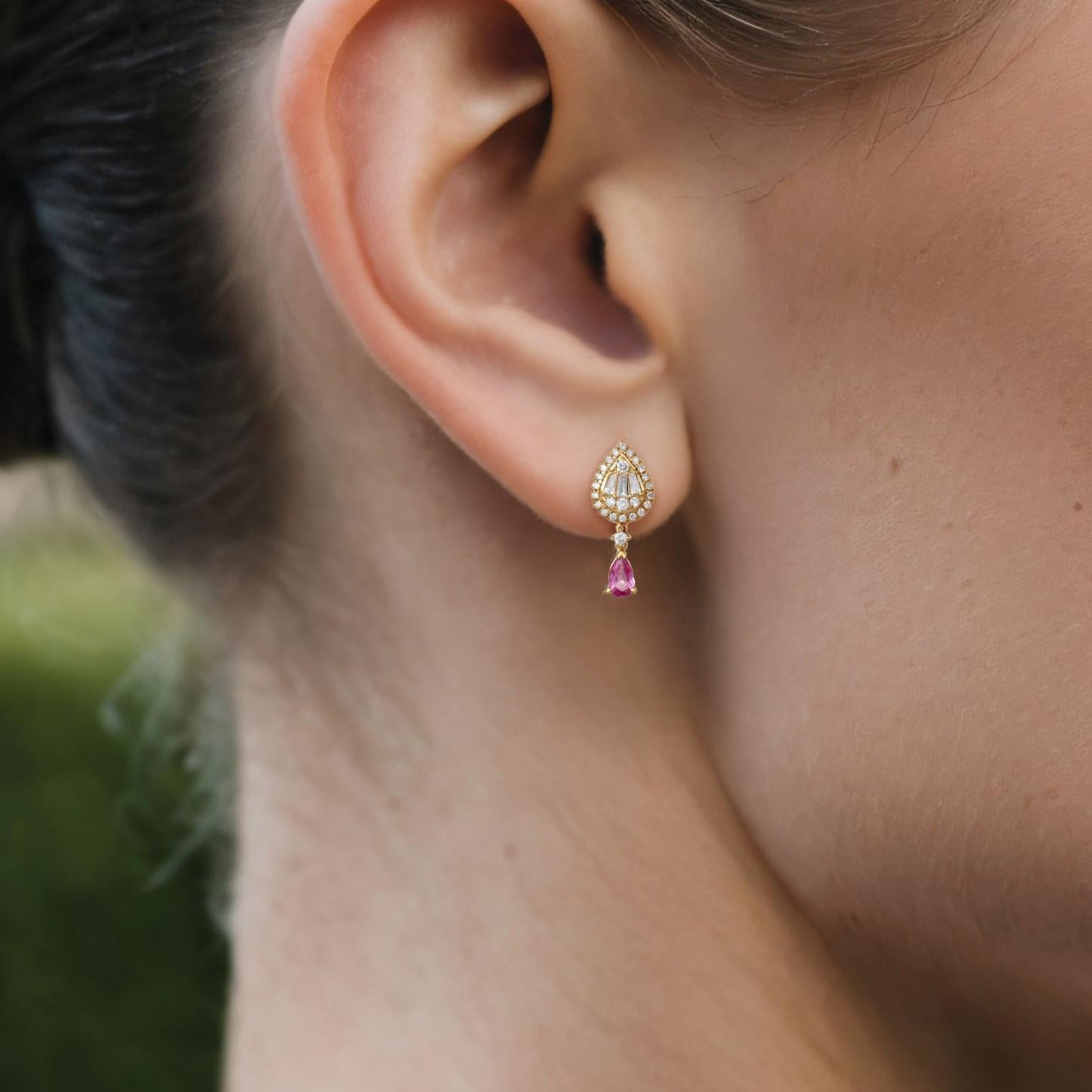 Indulge in timeless elegance with the Pear Shape Radiant 14K Yellow Gold Drop Earrings. Crafted in a lightweight 1.93g design, they feature 0.25ct of full-cut diamonds, 0.14ct of baguette diamonds, and 0.46ct of pear-shaped diamonds. This exquisite