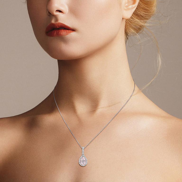 Set in a halo of diamond accents, a pear-shaped rose quartz  center take center stage. The small diamond accents complement the pendant. The pendant is a great anniversary or birthday gift.

Information
Metal: 18K White Gold
Width: 11 mm.
Length: 24