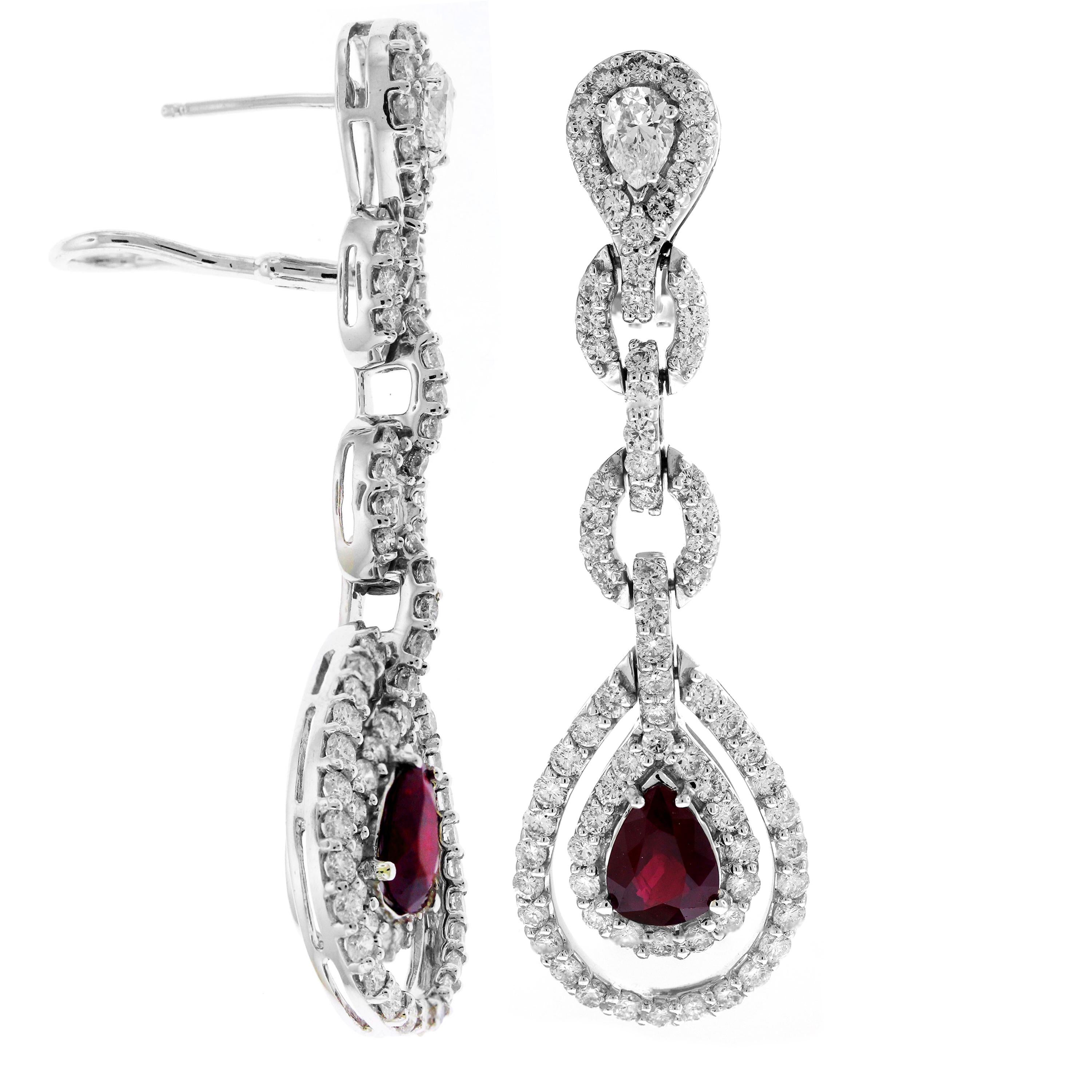 Pear Shape Ruby and Diamond 18 Karat White Gold Drop Dangle Earrings

3 carat approximate pear shape Rubies

6.25 carat G color, VS clarity white diamonds

Earrings measure 2.3 inches in length x 0.7 inch width

Post omega backs for security

Made