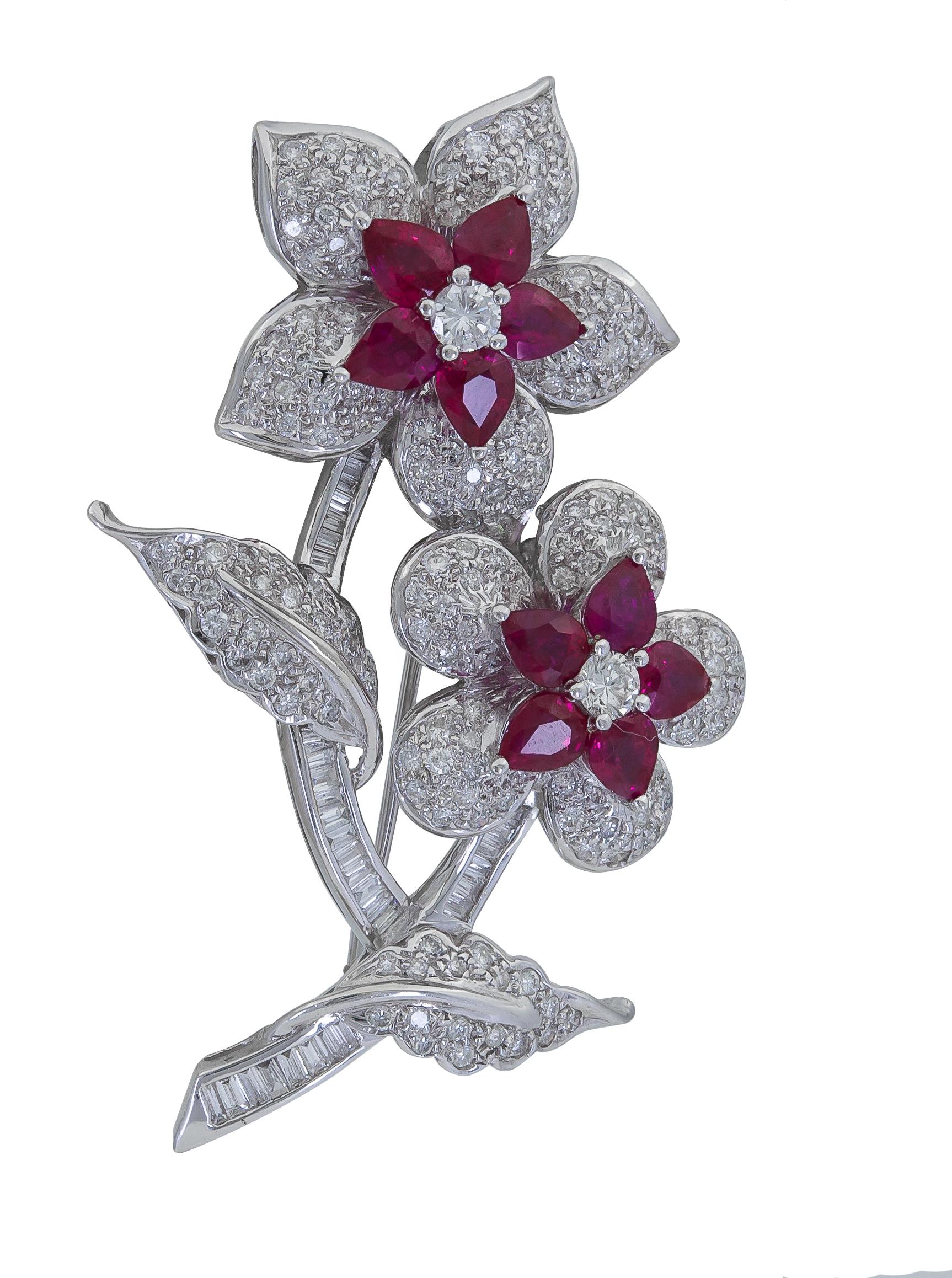 An expertly-crafted brooch featuring a combination of pear shape rubies and round brilliant diamonds arranged in a beautiful floral motif. 
Rubies weigh approximately 4.00 carats total.
Diamonds weigh approximately 4.00 carats total.
Dimensions: