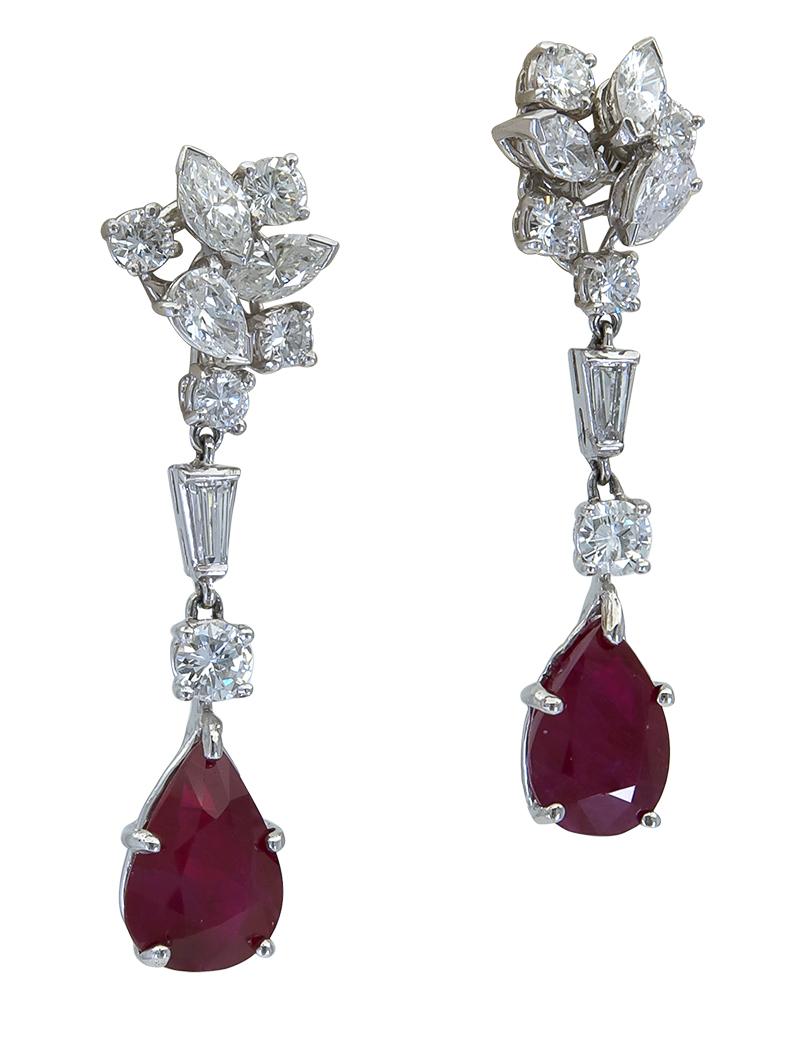 Chic style earrings featuring pear shape rubies weighing 3.36 carats total. Rubies are of Burmese origin and are heated. Suspended on an elegant display of mixed cut brilliant diamonds weighing 2.10 carats total. Made in platinum. Screw-back