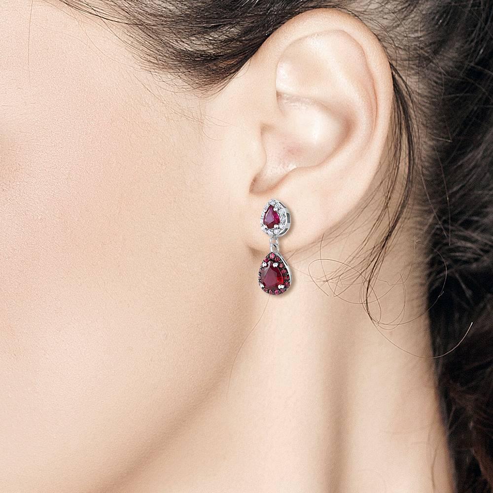 Featuring 18k white gold halo diamond and ruby earrings with pear shape ruby drops 
Ruby Weighing 2.80 carats 
Diamonds weight 0.30 carat
New Earrings
Our team of graduate gemologists carefully hand-select every diamond and gemstone, while our