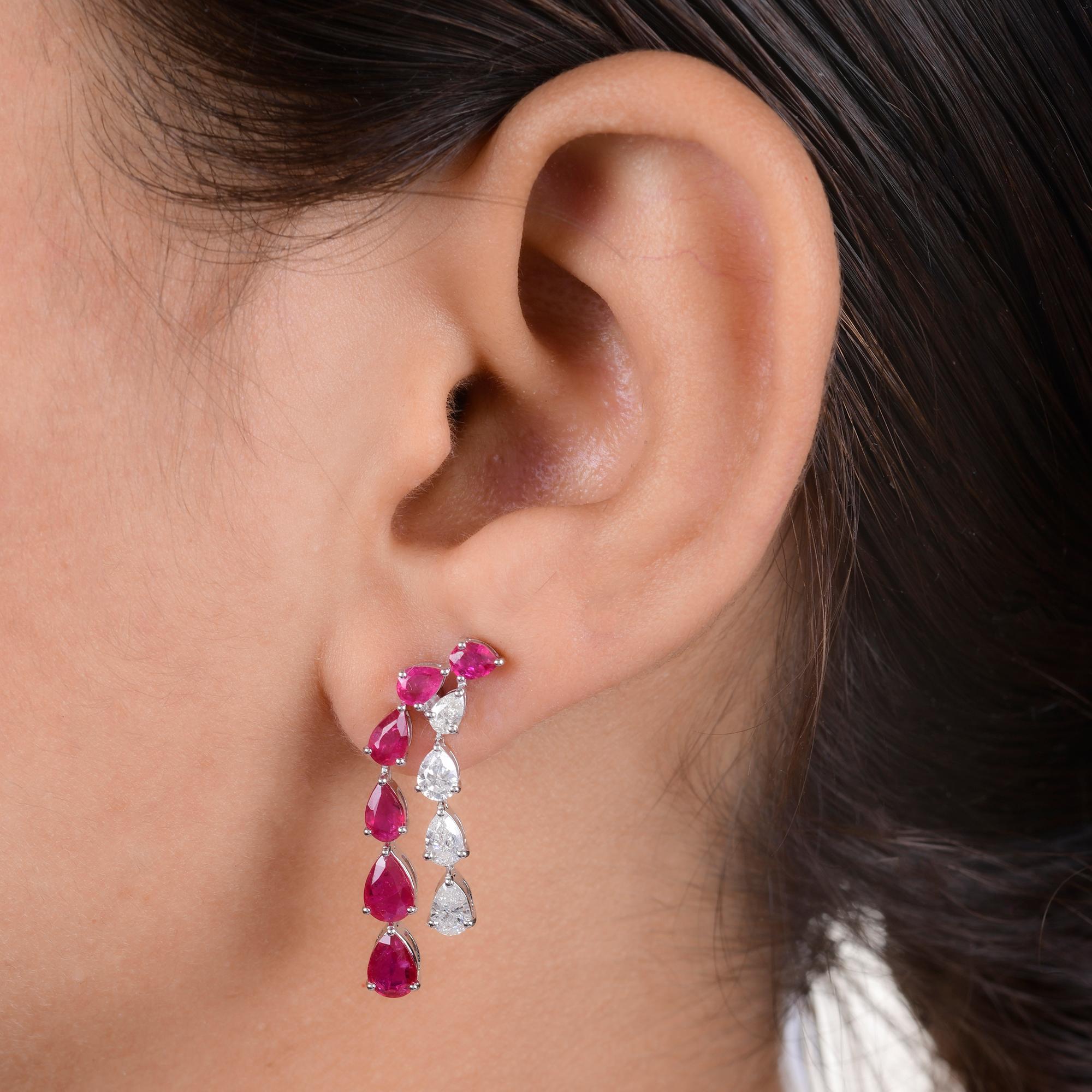 Indulge in the timeless allure of these Pear Shape Ruby Gemstone Dangle Earrings, adorned with sparkling Diamonds and crafted in luxurious 18 Karat White Gold. Each earring is a stunning testament to sophistication and elegance, designed to