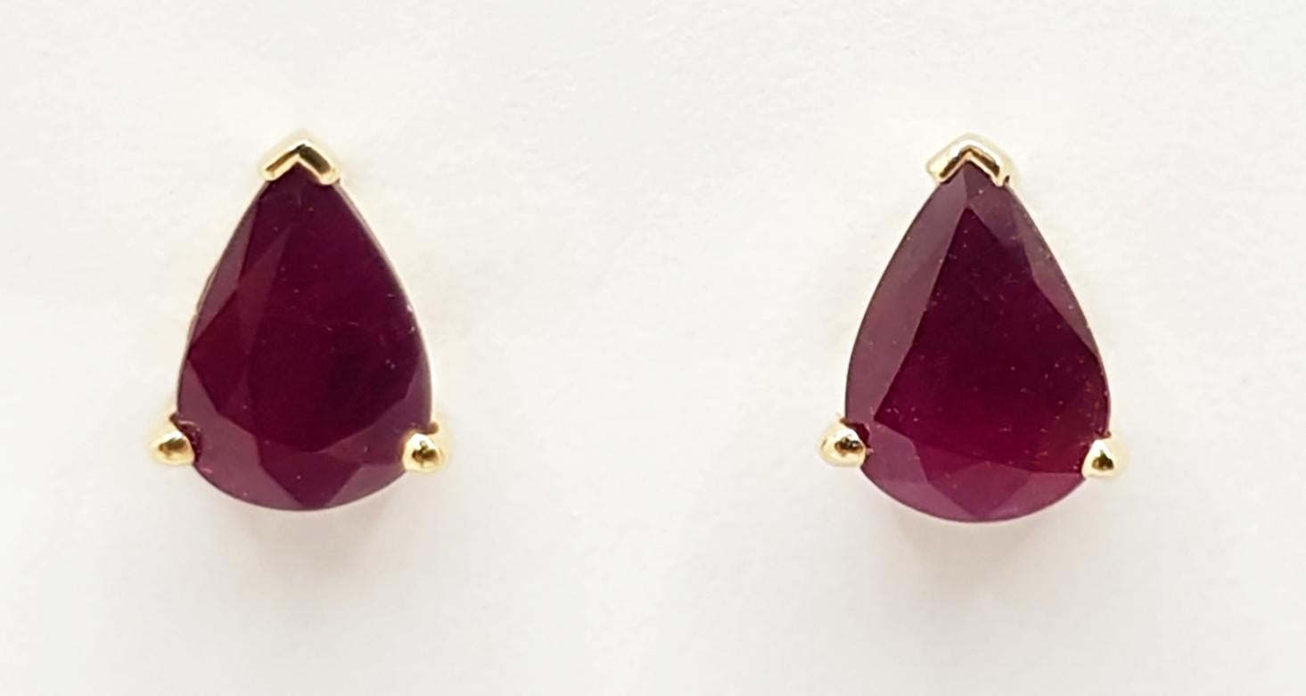 Contemporary Pear Shape Ruby Stud Earrings Set in 14 Karat Gold Settings For Sale