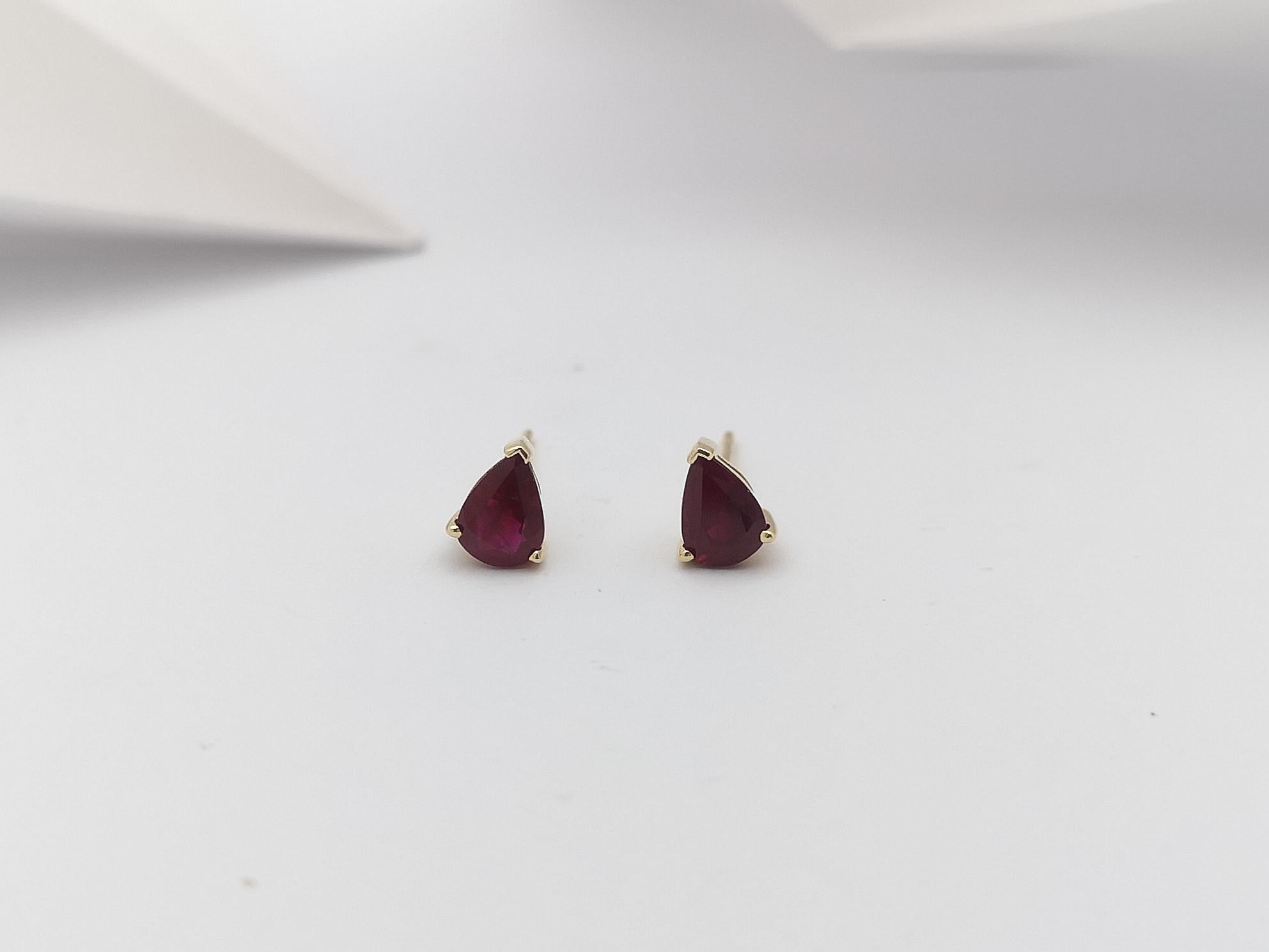 Women's Pear Shape Ruby Stud Earrings Set in 14 Karat Gold Settings For Sale