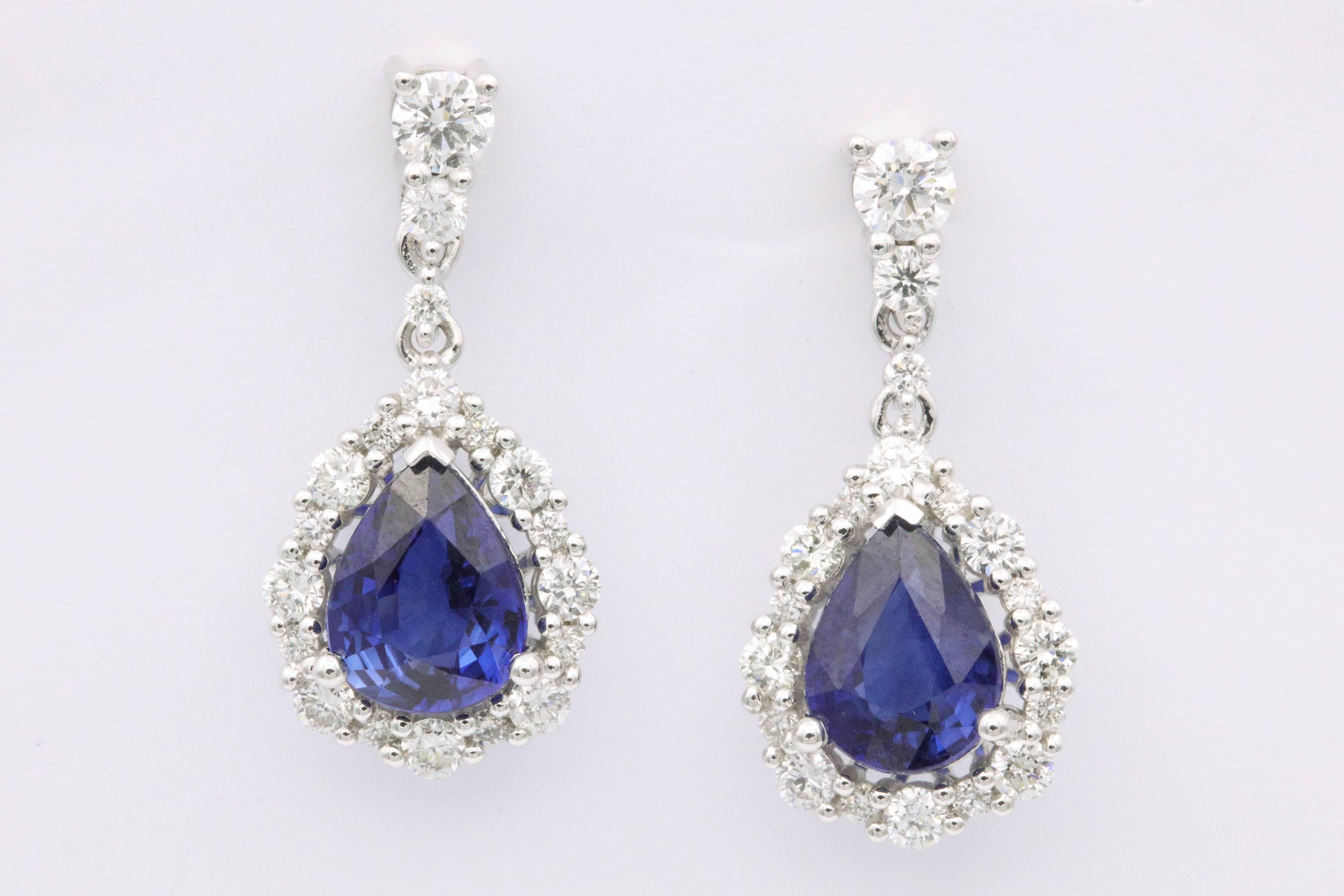 2 Sapphires 2.5 carats T/W 
38 diamonds 0.83 Carats T/w
Each Sapphire is measuring 8 X 6 mm
The Earrings are 2 cm long/ 0.80 inches
18K white gold
