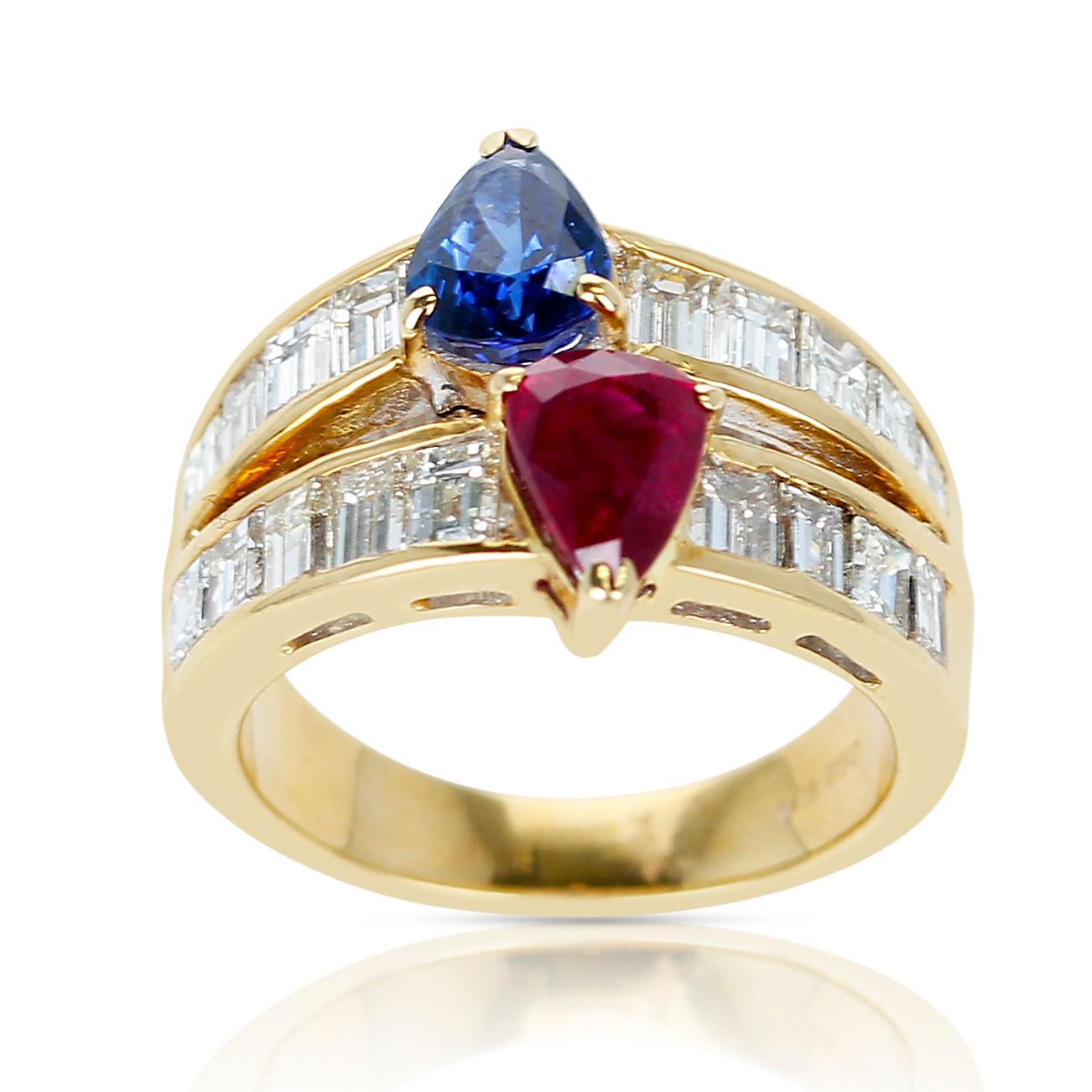 A Pear Shape Sapphire and Ruby Ring with Emerald-Cut Diamonds made in 18k Yellow Gold. The Ruby weighs appx. 1.04 carats, the sapphire weighs appx. 1.17 carats, and the diamonds weigh 2.15 carats. The total weight of the ring is 8 grams. Ring Size