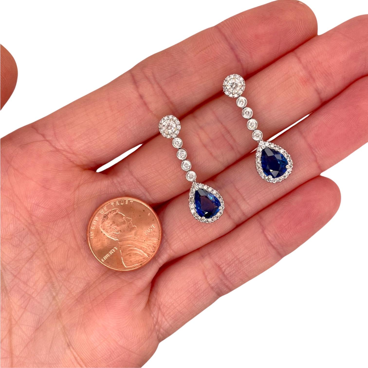 Earrings contain 2 pear shape brilliant sapphires, 2.48tcw and round brilliant diamonds , 0.86tcw. Diamonds are G in color and SI1 in clarity, excellent cut. Sapphires measure approximately 8x6mm. All stones are mounted within handmade 18k white