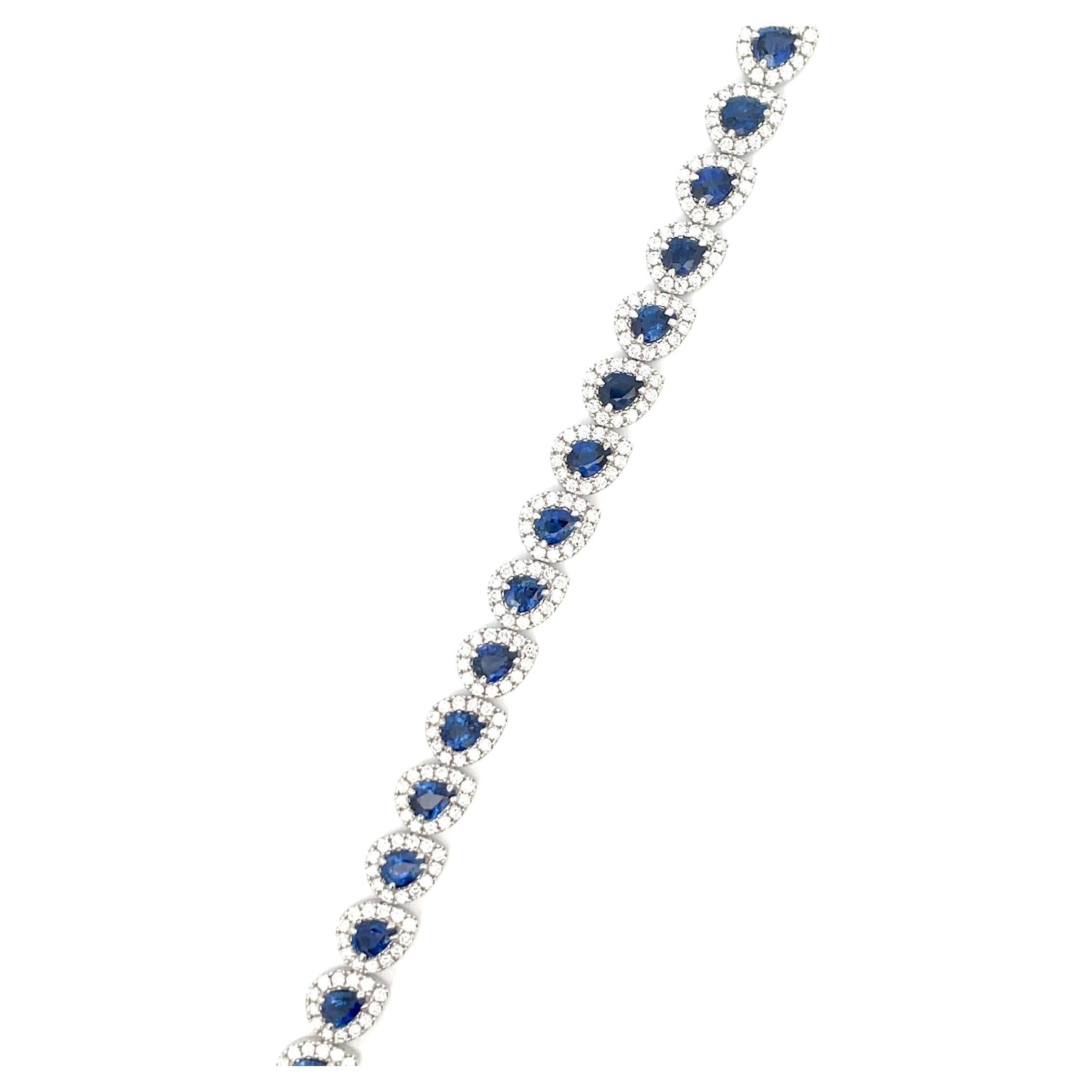 Twenty-three Pear shape blue Sapphires weighing 8.98 Carats flanked with a halo of 299 round brilliants weighing 3.31 carats, in 18 Karat White Gold. 
Color G-H
Clarity SI