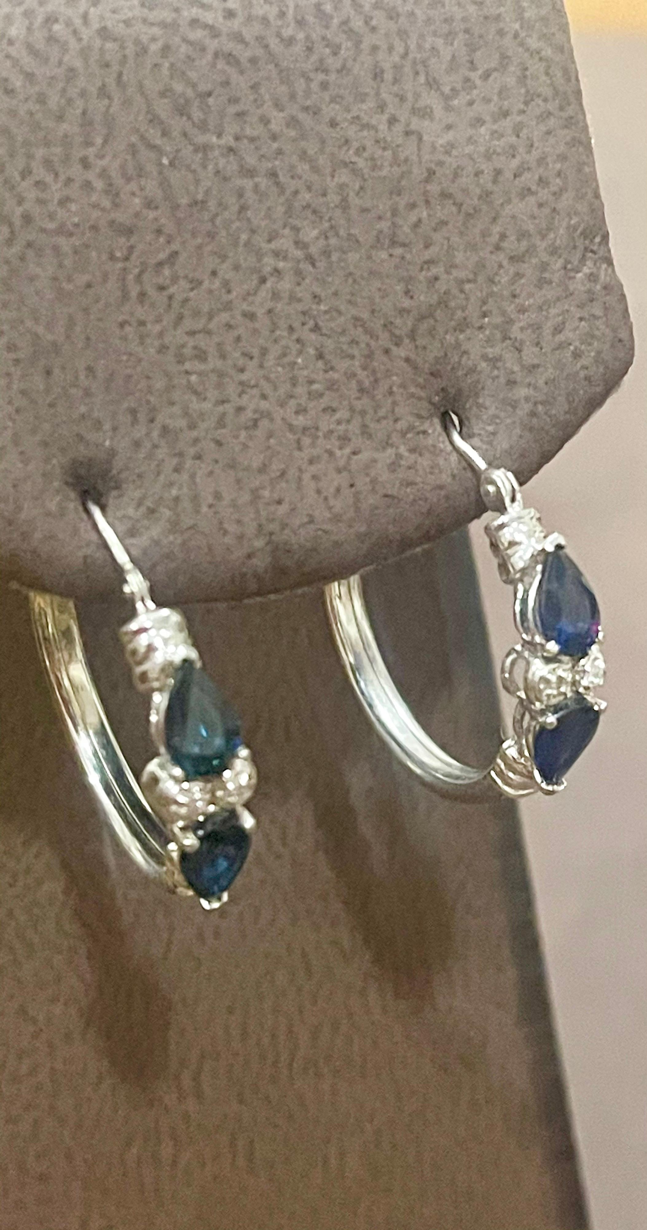 Pear Shape Sapphire & Diamond Hoop Cocktail Earrings in 14 Karat White Gold
A fabulous pair of earrings with an enormous amount of look and sparkle!
These exquisite pair of earrings features 4 Pear shape Blue Sapphire approximately 1 ct
 There are