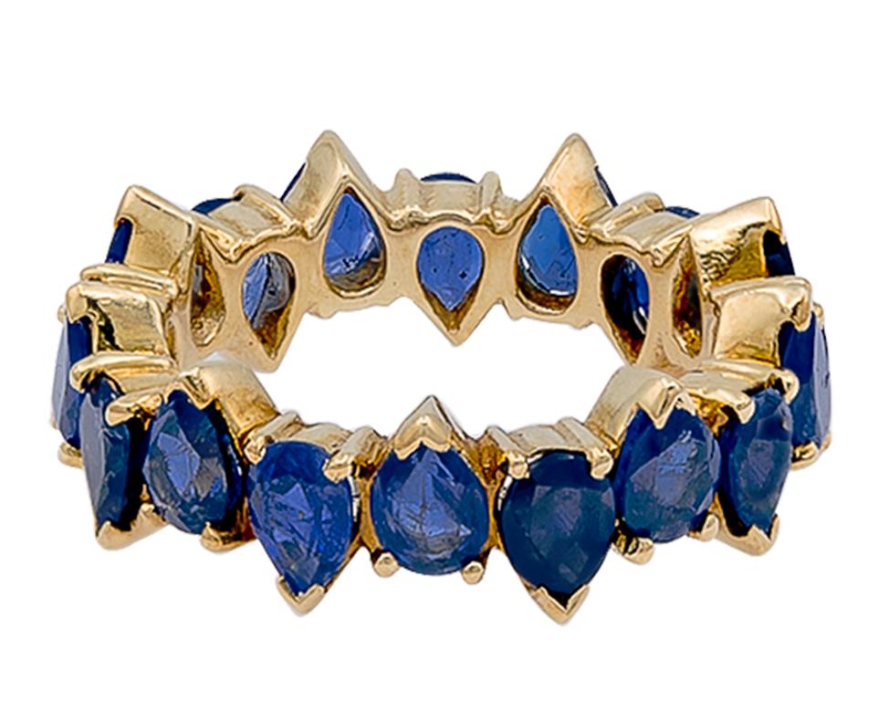 A distinctive piece this one is! This one of a kind Sapphire Pear Shape eternity band exudes 18 stones of blue sapphires, by Ely Adams Inc. The total sapphire weighs approximately 4 carats. It is set alternating up and downs which gives it a little
