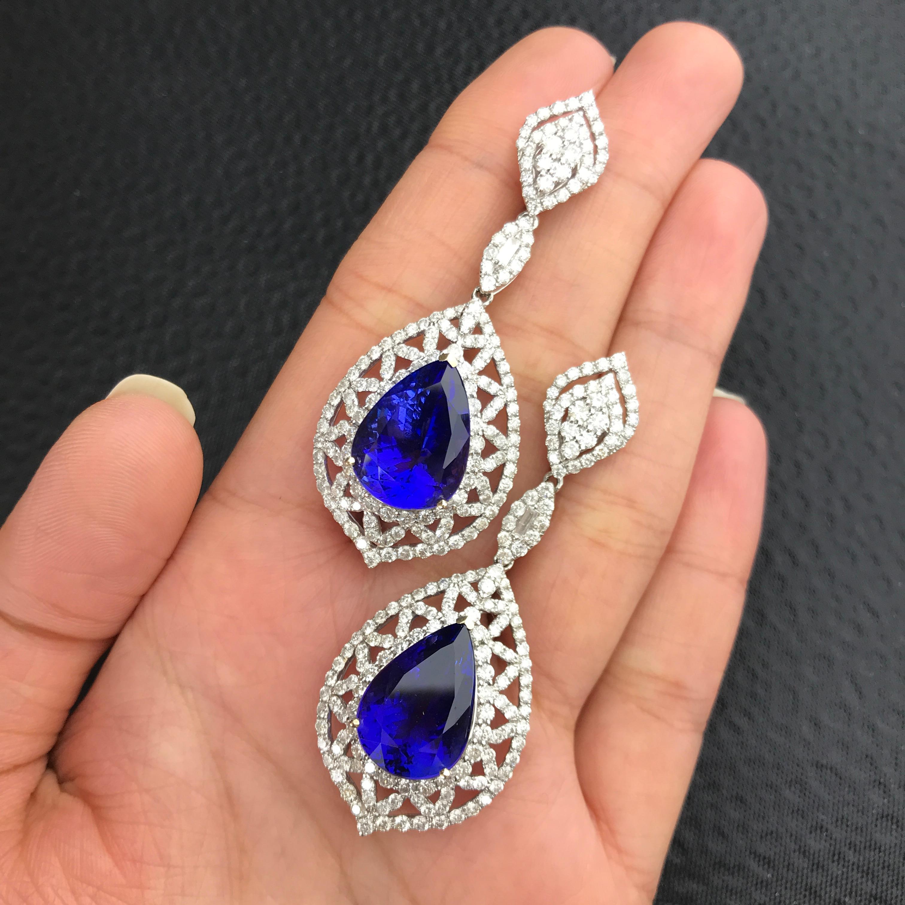 A beautiful, classic set of Pear shaped, top colour, Tanzanites, adorned with brilliant cut and marquise White Diamonds all set in 18K White Gold. The earrings and ring centre stone is loupe clean, however there is a small inclusion in the Tanzanite