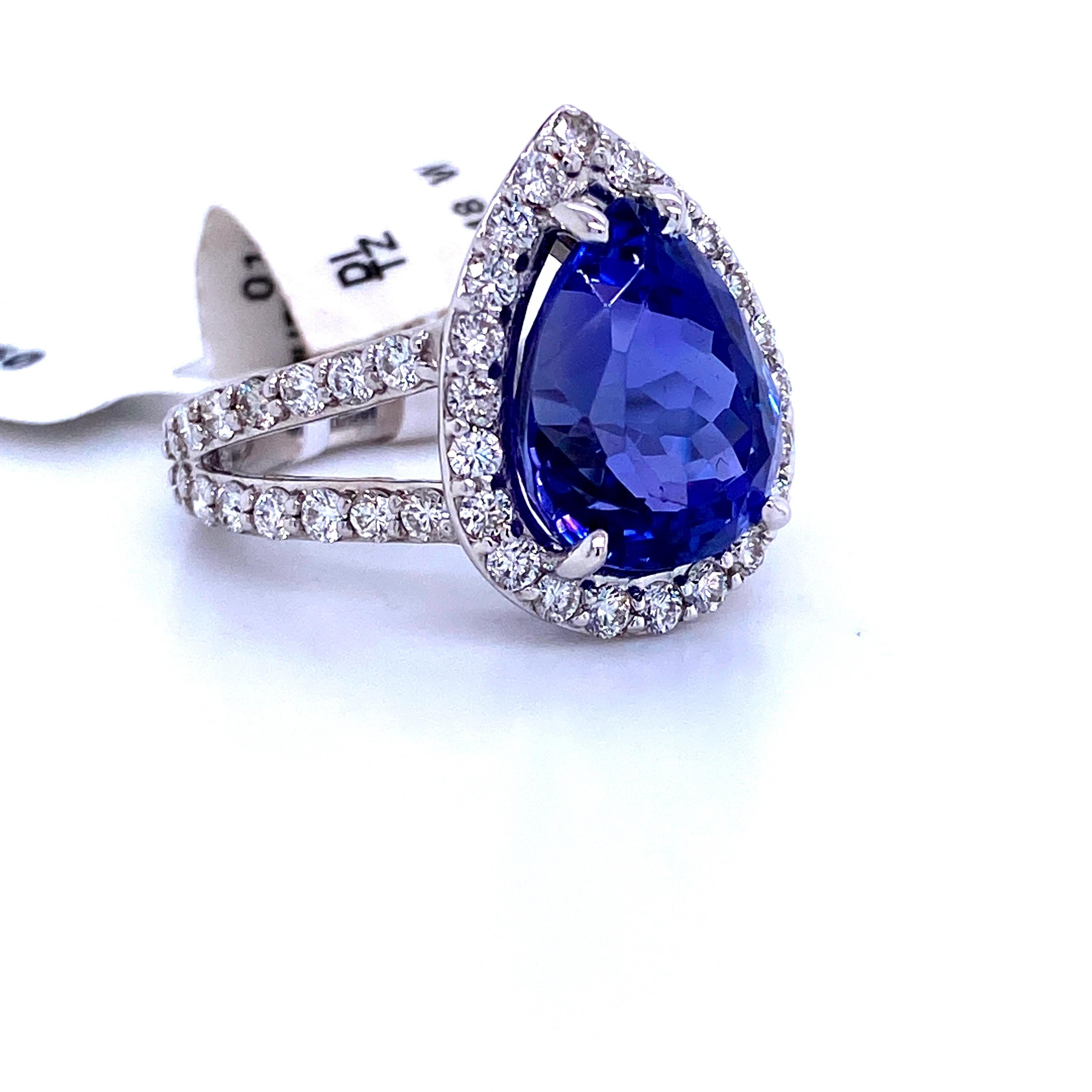 18K White gold cocktail ring featuring one pear shape Tanzanite weighing 8.32 carats flanked with a diamond halo and split shank mounting weighing 1.50 carats.
Color G-H
Clarity SI