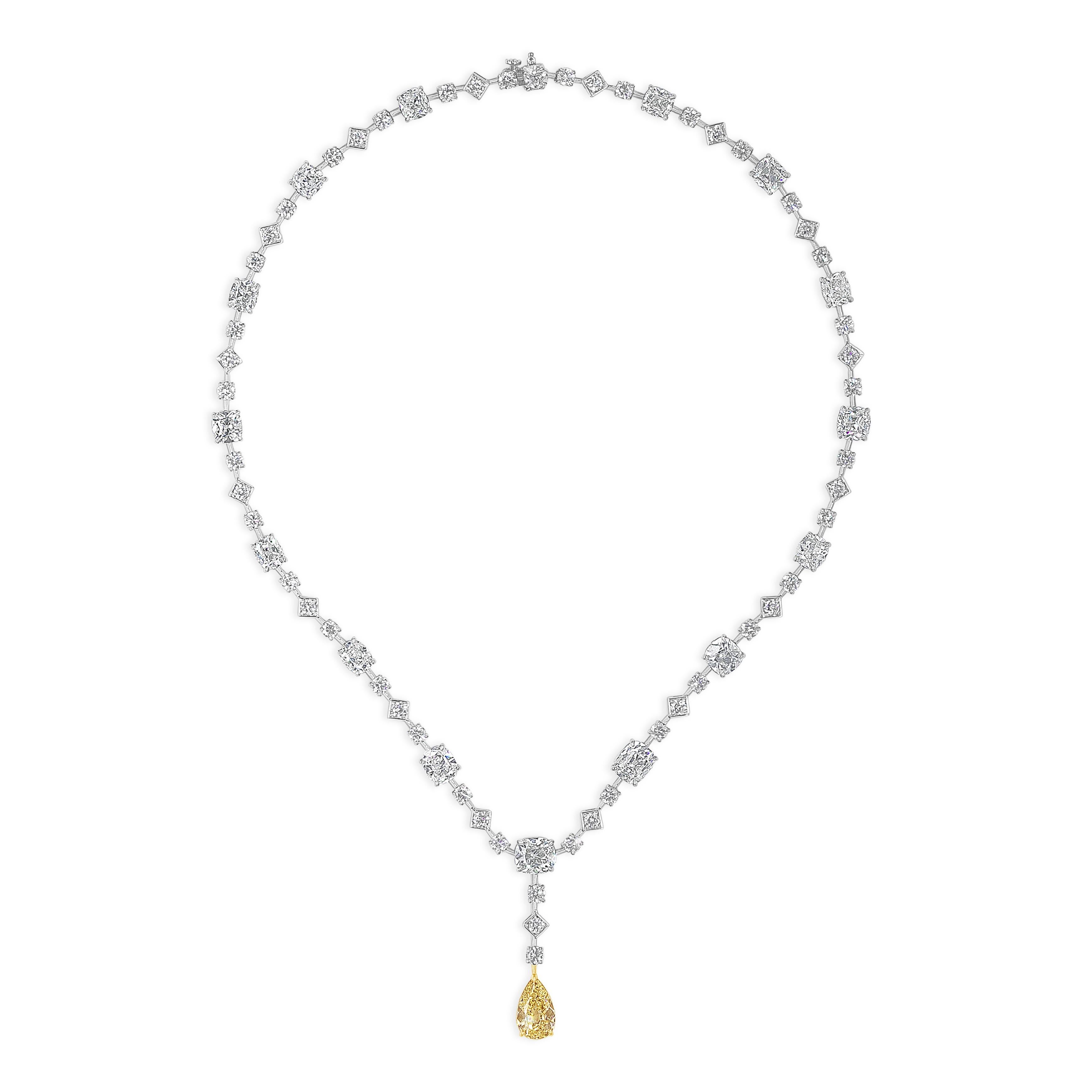 A unique and beautiful drop necklace showcasing a yellow pear shape diamond weighing 2.79 carats, that elegantly drops from a diamonds by the yard necklace. Accent diamonds weigh 26.12 carats total. Made in platinum.