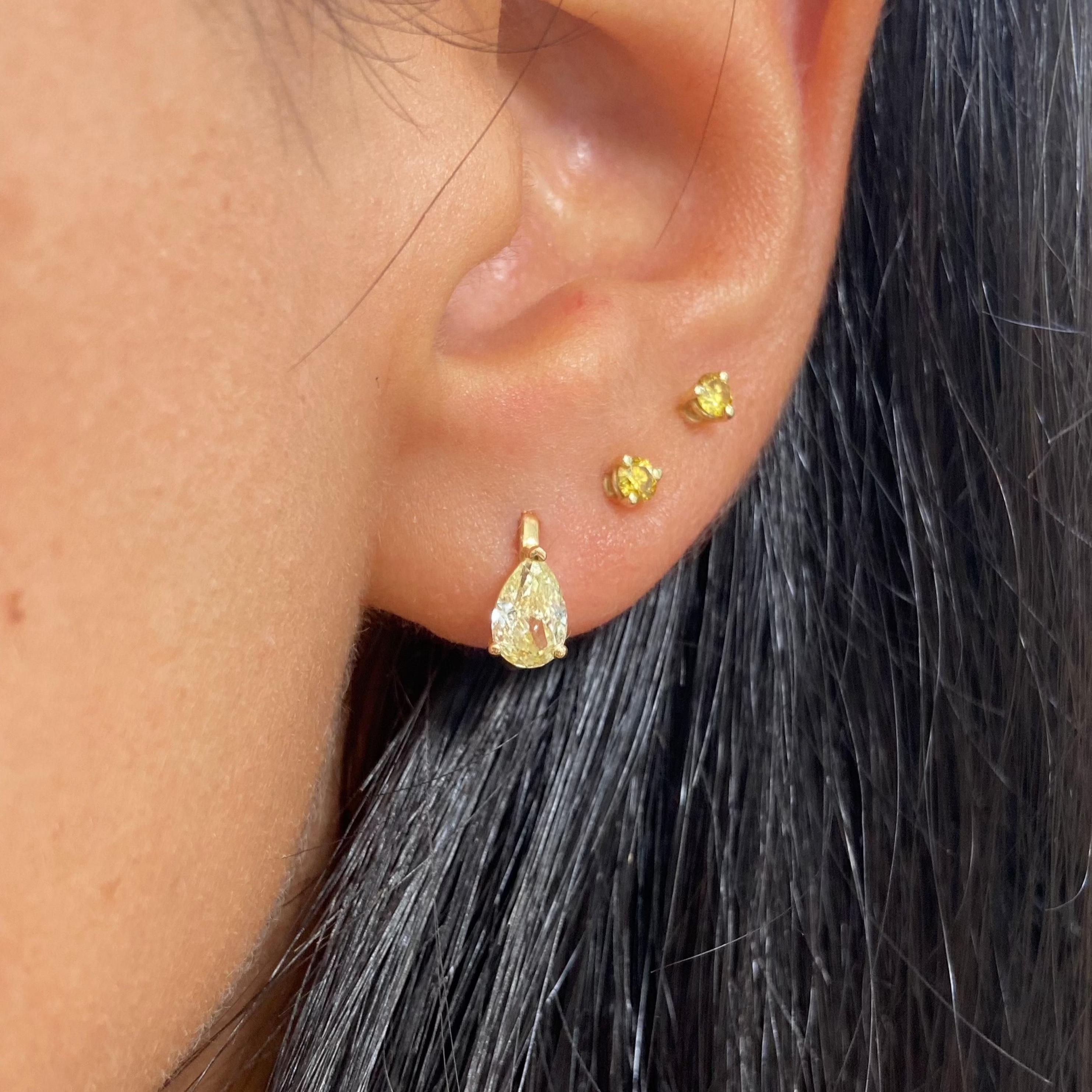 1.25 Carats
Light Yellow Diamonds
Pear Shape Diamonds
VS+ Clarity
Natural white diamond pave
Crafted in 18k Yellow Gold
Handmade in NYC

AtAt Rare Colors, you can experience the elegance of our exquisite fancy colored diamonds in person. This piece