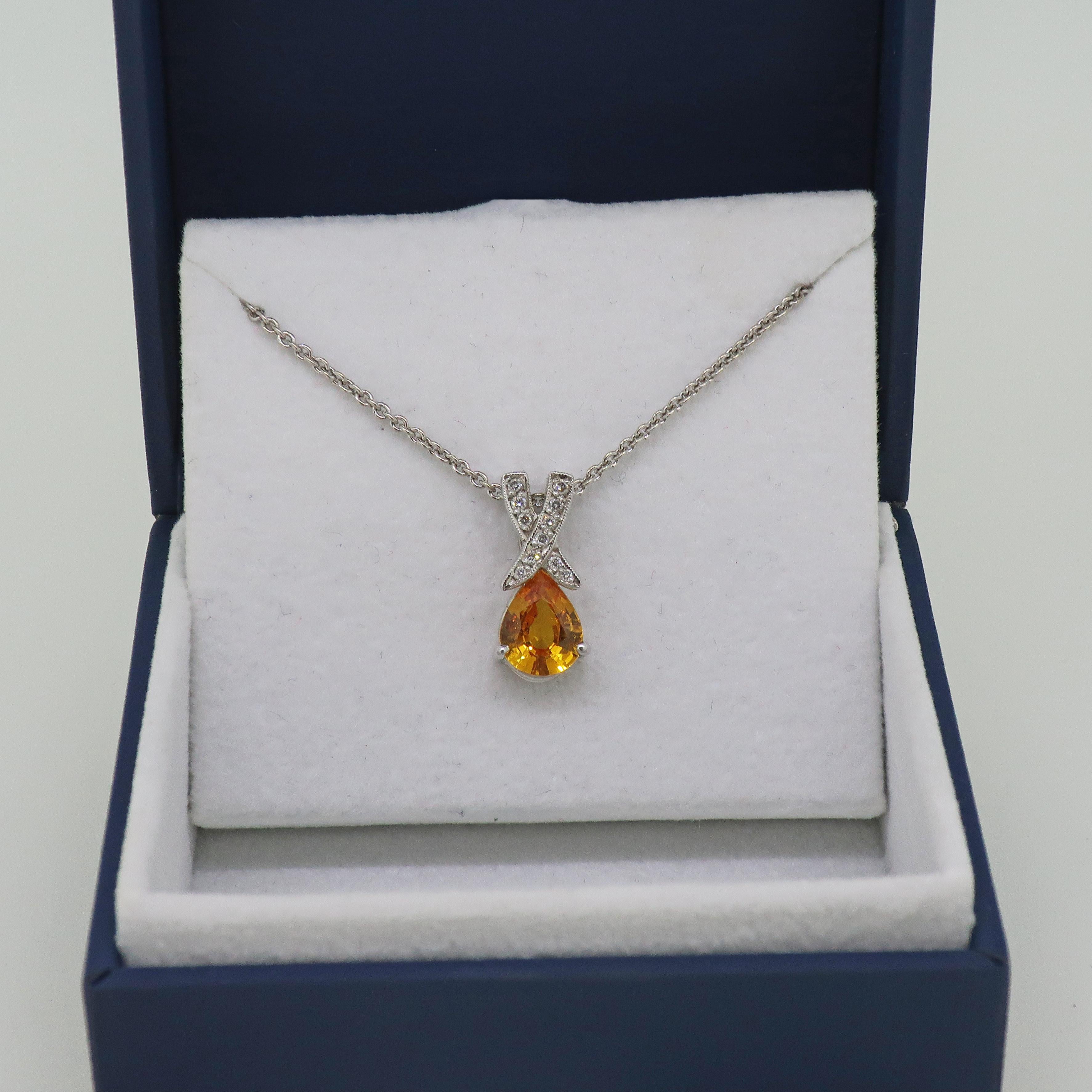 Yellow Sapphire and Diamond Pendant 18 Karat White Gold 

Gorgeous yellow sapphire and diamond pendant. Bright and vibrant pear shape yellow sapphire measuring 9mm x 7mm, with a diamond top. Two bands of brilliant cut diamonds crossing over each