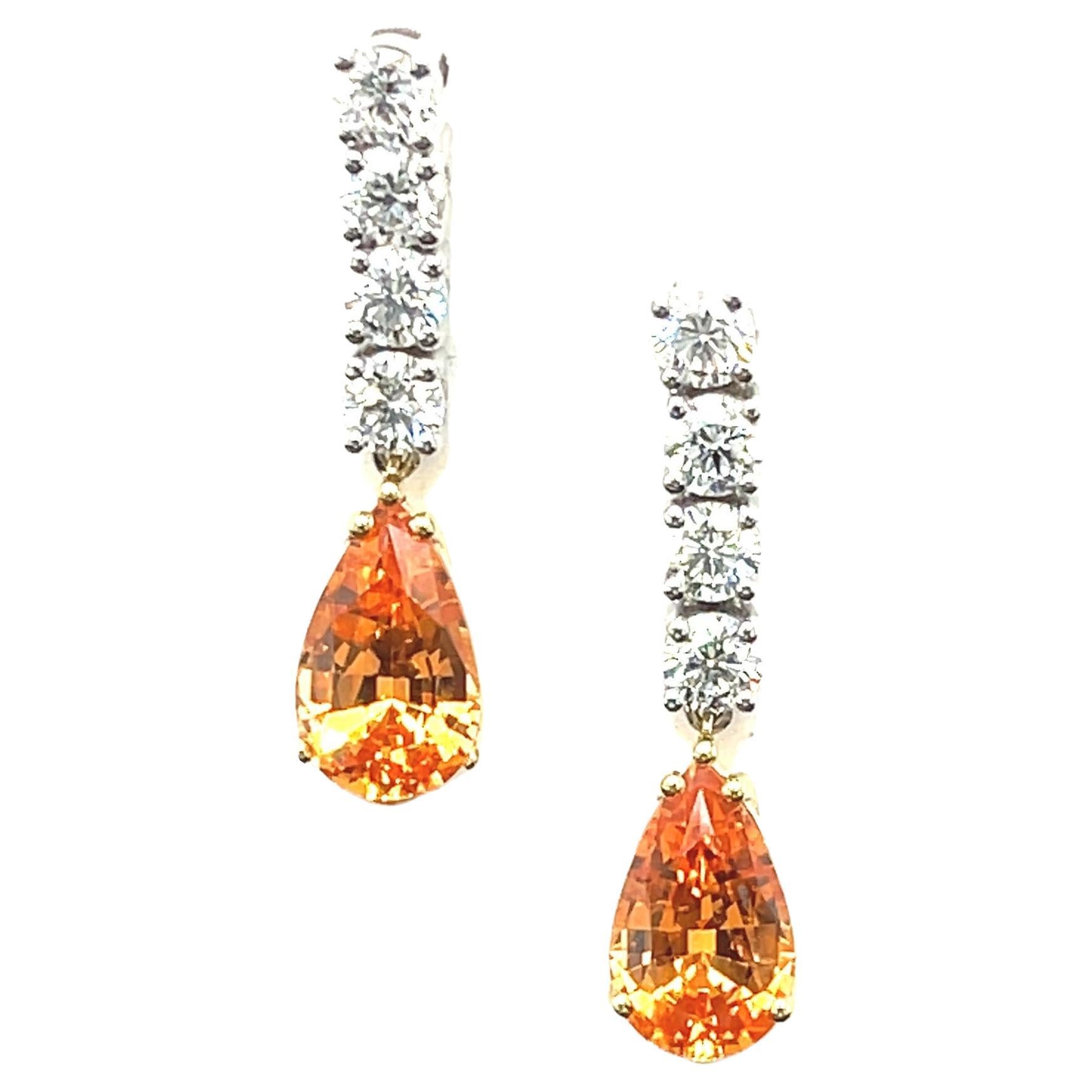 Wow! These spectacular drop earrings feature a perfectly matched pair of brilliant pear-shaped orange spessartite garnets weighing almost 2 carats apiece! Spessartite garnets, also known as spessartine are a variety of garnets originally discovered