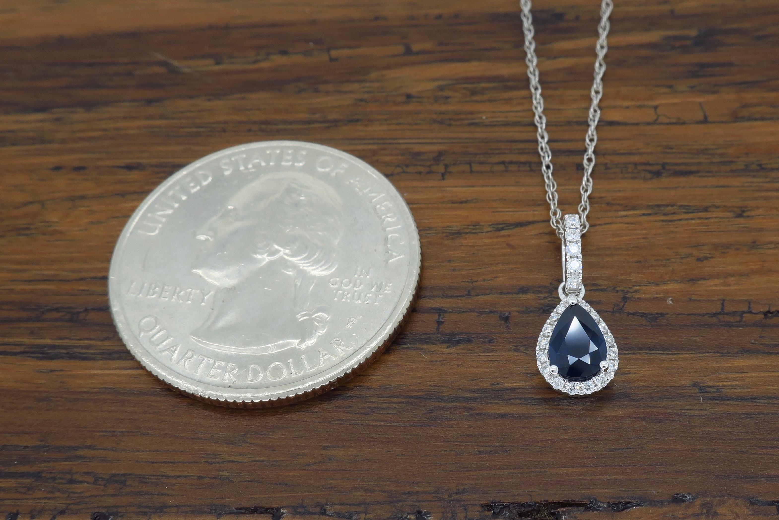 Stunning halo style necklace featuring a .47CT Pear Shaped Blue Sapphire surrounded by 32 Round Brilliant Cut Diamonds

Gemstone: Diamond & Blue Sapphire
Gemstone Carat Weight: .47CT Pear Shaped Blue Sapphire
Diamond Carat Weight: Approximately