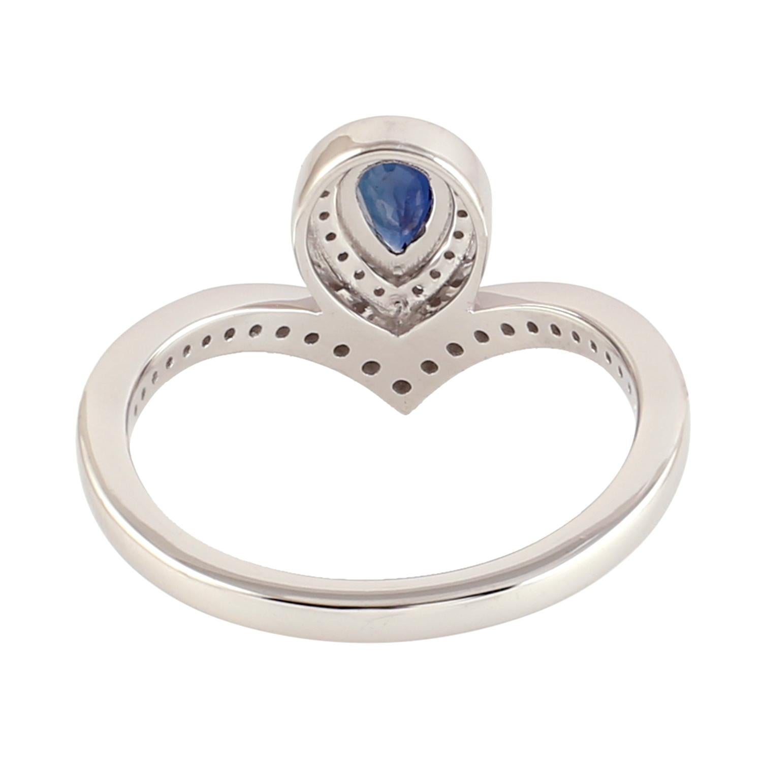 This stunning ring features a pear-shaped blue sapphire with pave diamond setting and made from 18k white gold. The sapphire is a rich, deep blue color and is cut into a pear shape, which gives the ring a unique and elegant look. The pave diamond