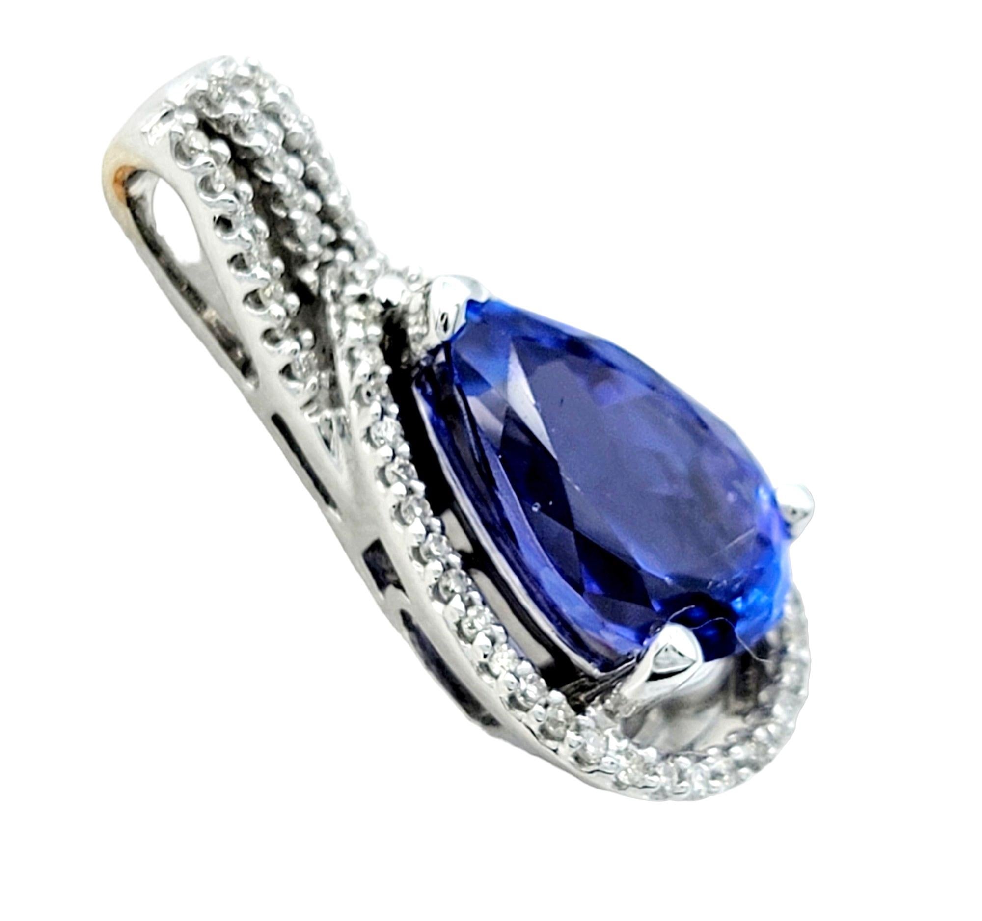 Contemporary Pear Shaped Blue Tanzanite Pendant with Diamond Halo Set in 14 Karat White Gold For Sale