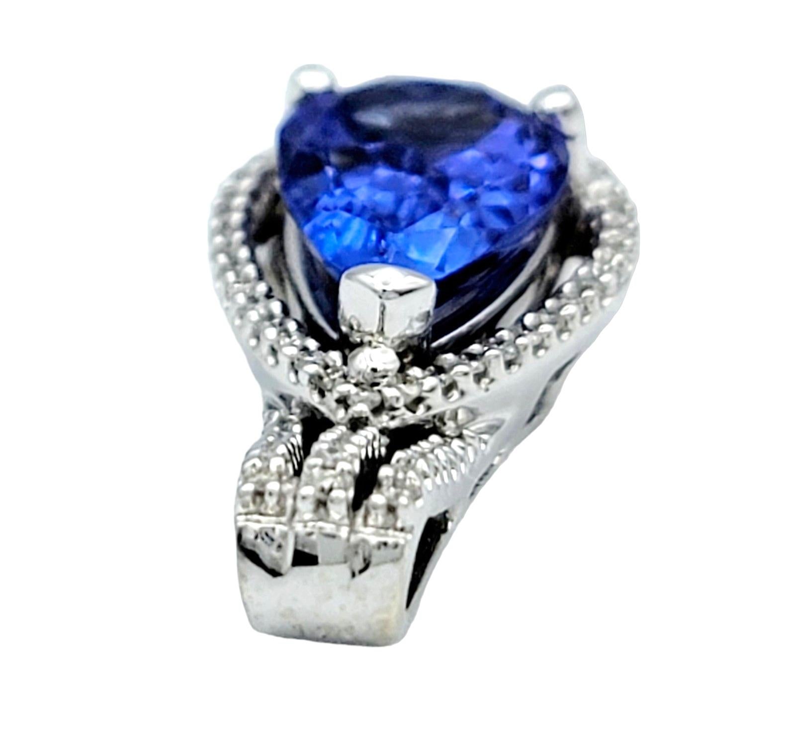 Women's Pear Shaped Blue Tanzanite Pendant with Diamond Halo Set in 14 Karat White Gold For Sale