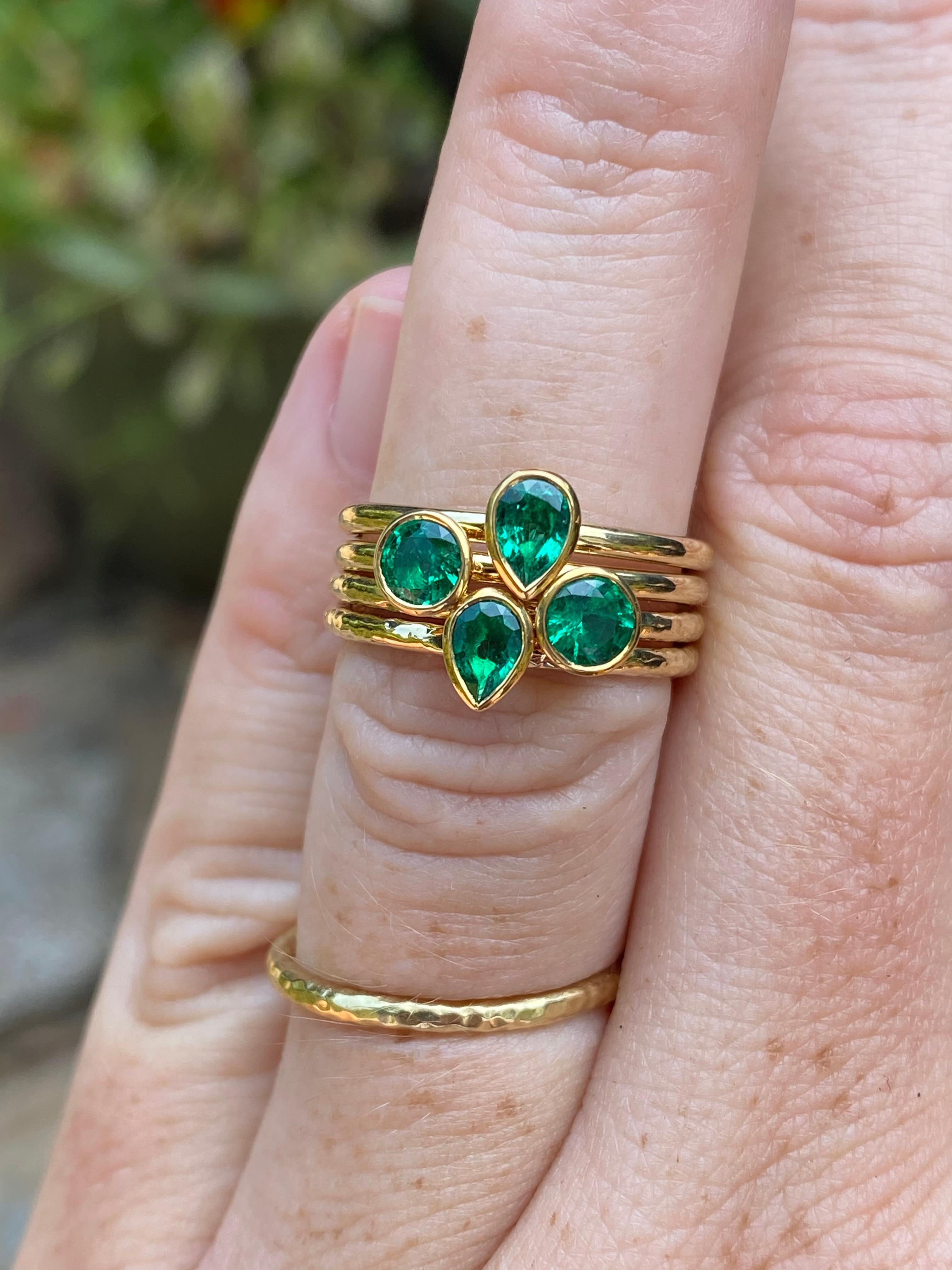 A clean and bright Colombian pear shaped emerald is featured in this hand forged stacking ring. It is crafted in 22 and 18 karat gold by our master goldsmith in California. The price as listed is for one ring. 

-Colombian emerald pear of 0.35
