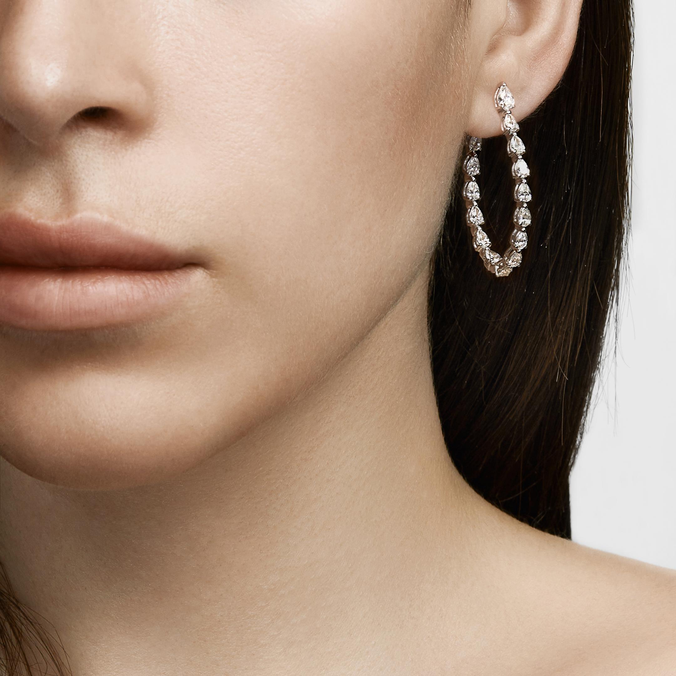 Elegant pear-shaped diamonds create an ultra-luxurious version of your go-to statement hoop earrings. The Pear-Shaped Diamond Hoop Earrings feature an “inside out” design with diamonds lining the inner edge that ensures you see twice the amount of