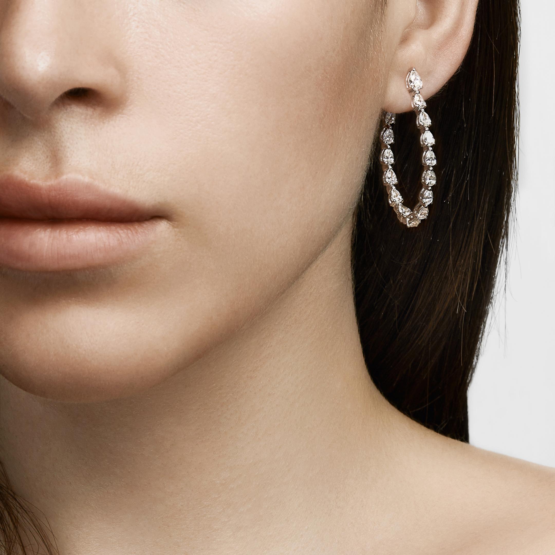 You will be radiant in our Pear-Shaped Yellow Diamond Hoop Earrings. A single pear-shaped white diamond sits at the ear lobe, then gives way to a cascade of pear-shaped fancy yellow diamonds. These diamond hoops are an inside-out style, meaning