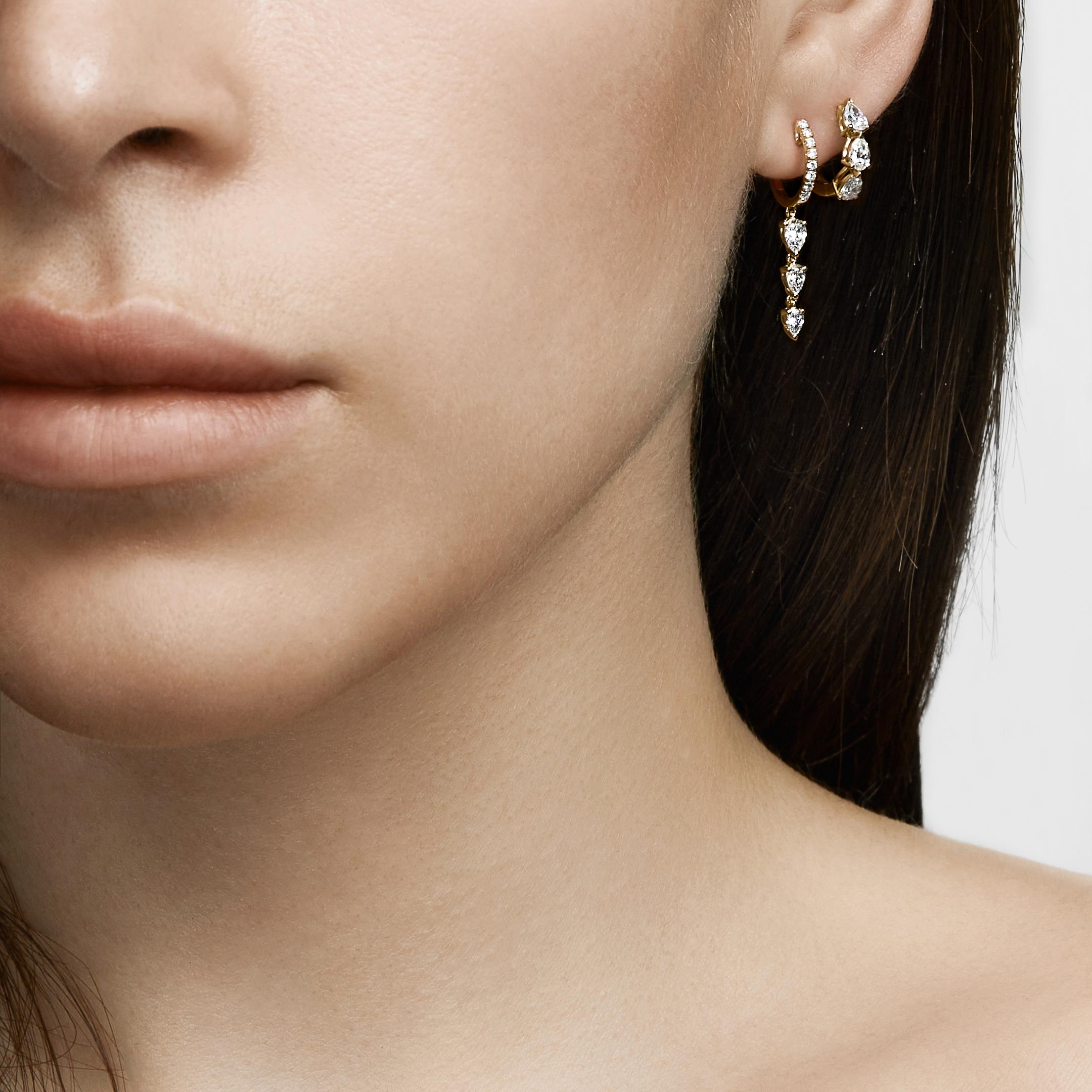 Everyone needs a perfect diamond hoop earring to take them from the office to dinner plans to weekend brunch with friends. The Pear-Shaped Diamond Huggies are just that versatile fine jewelry staple. Crafted in 18-karat yellow gold, these huggie