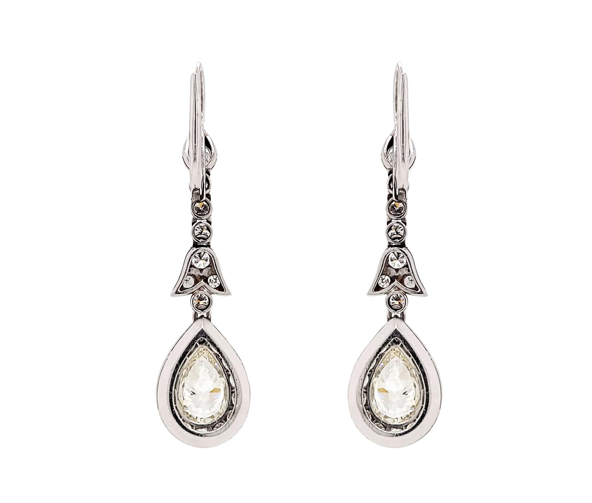 Beautiful drop earrings embellished with two pear-shaped light yellow diamonds weighing 1.50 carats each. 
The yellow diamonds are surrounded by 21 round diamonds. 
The estimated weight is 7 carats, F-G colors, VS-SI clarity.
The diamonds are not