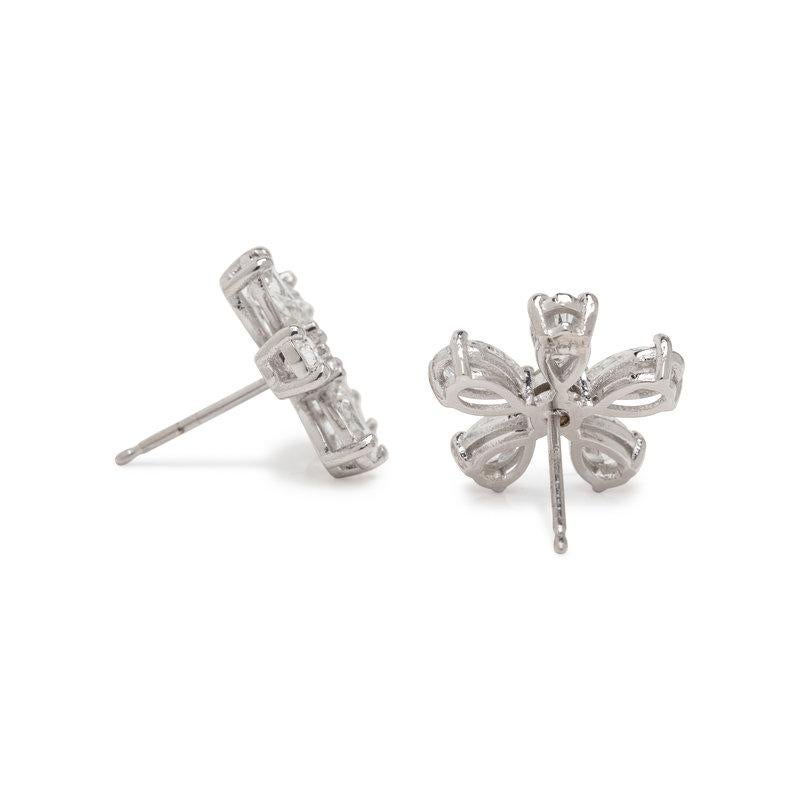 These flower earrings feature 10 pear shaped and two round brilliant cut diamonds, weighing approximately 3.00 carats total, and designed to appear as flowers. The diamonds are meticulously mounted in platinum. 