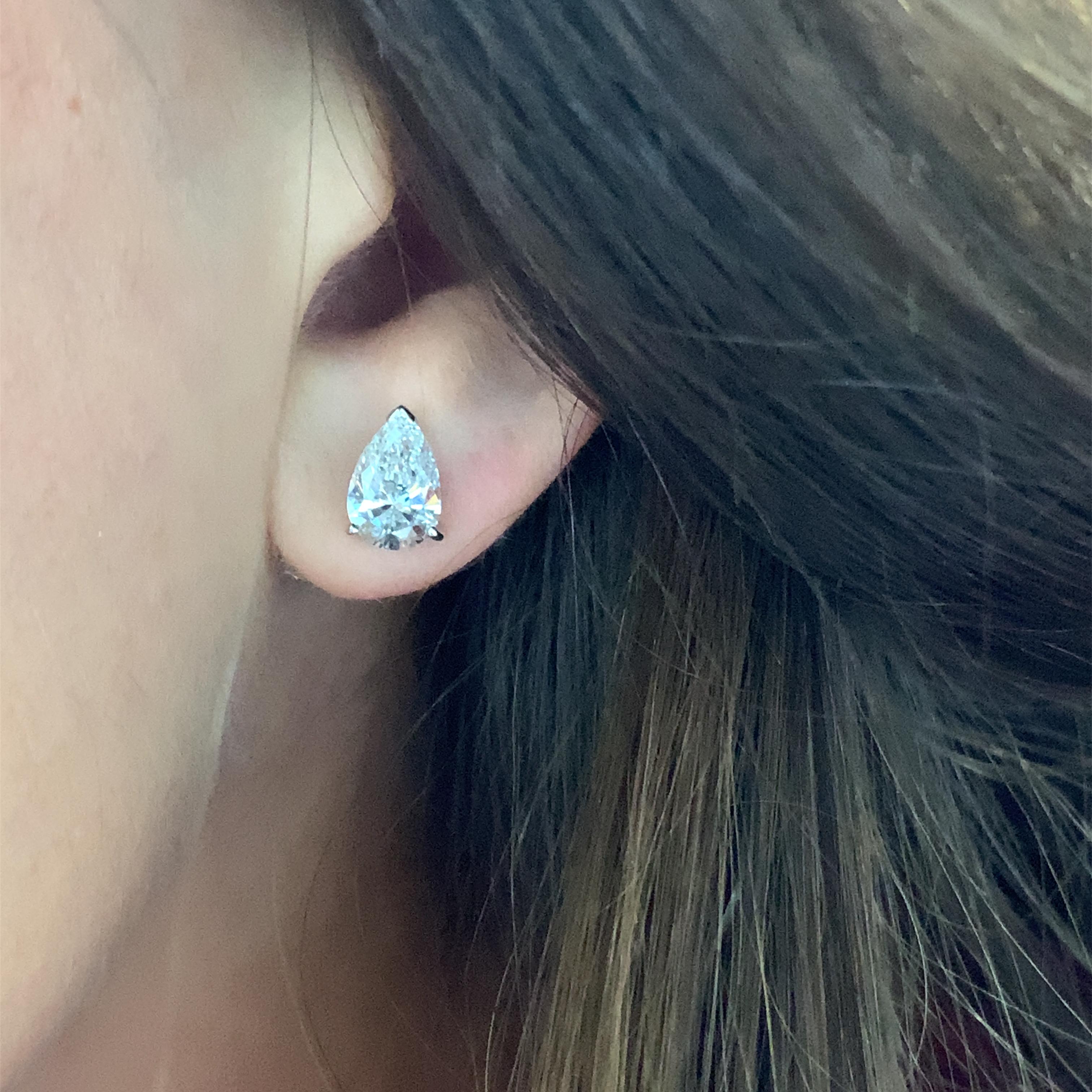 Add a touch of elegance to your look with these stunning stud earrings. Crafted from 18k white gold, these earrings feature a beautiful pear-shaped fancy cut diamond that will surely catch anyone's eye. The diamond is coloured with an intense F/G
