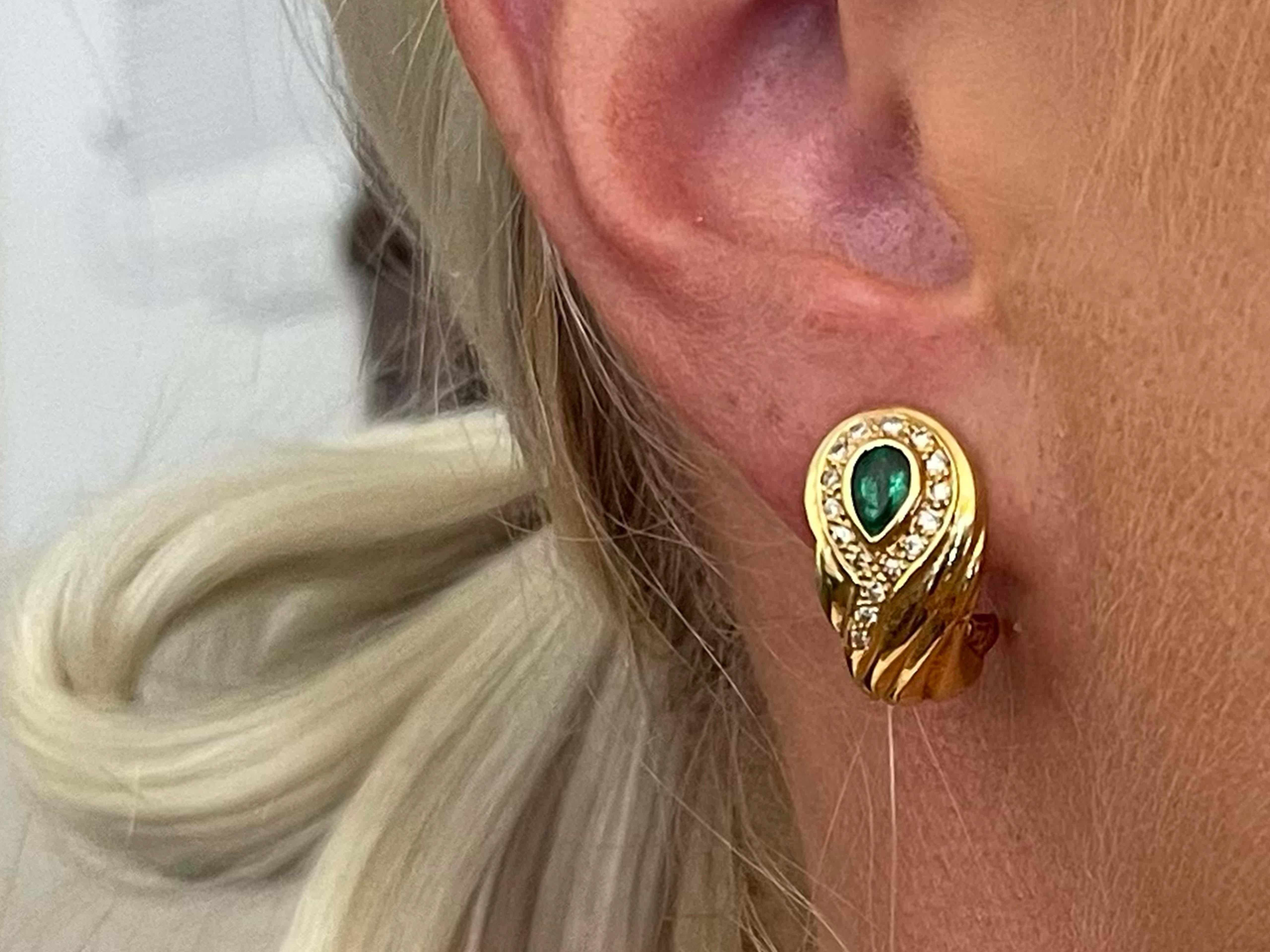 Earrings Specifications:

Metal: 18k Yellow Gold

Earring Length: 20.74 mm 
​
​Total Weight: 9.3 Grams

Emeralds: 2

Emerald Carat Weight: 1.00 carats

Diamonds: 32

Diamond Color: G

Diamond Clarity: VS

Diamond Carat Weight: 0.30