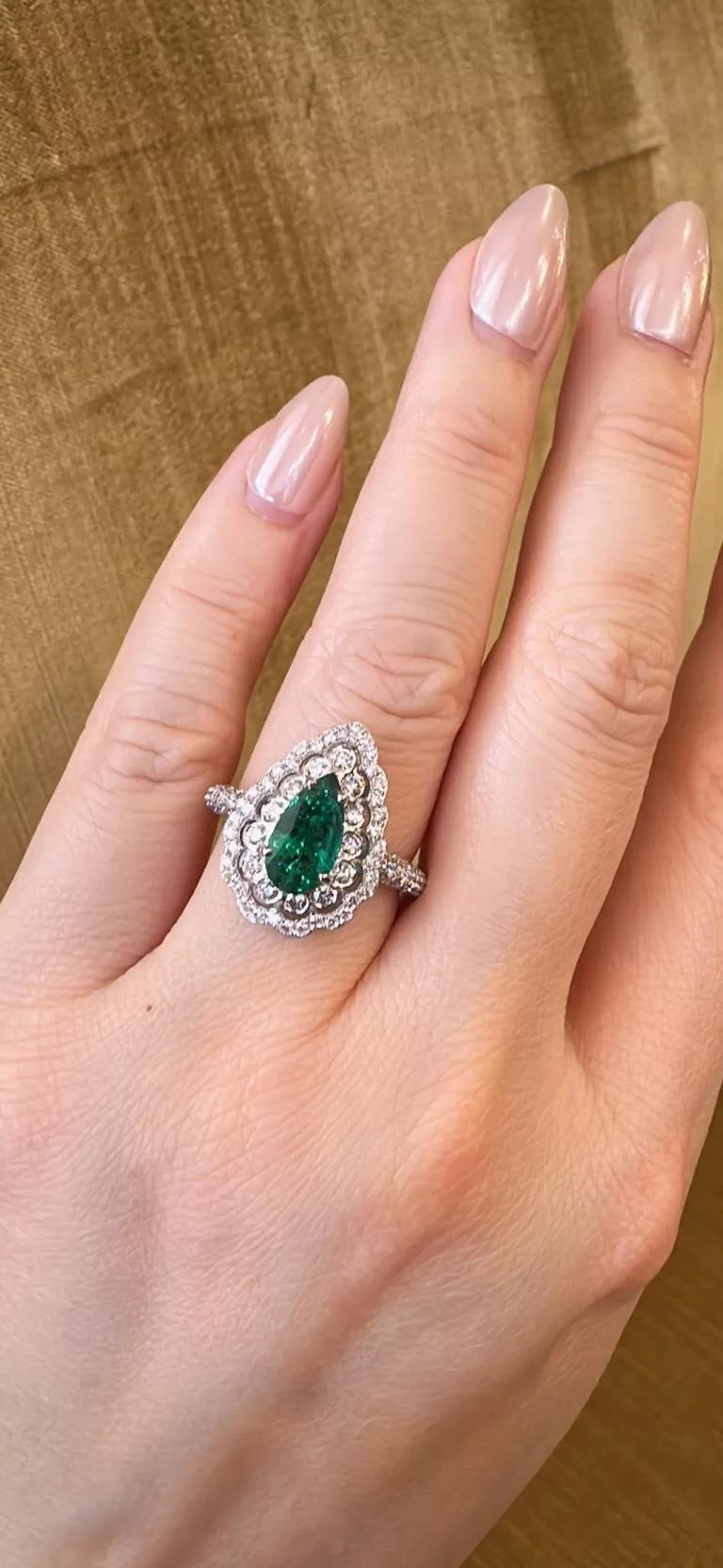 Anello con smeraldo a forma di pera e diamanti in oro bianco 18 carati 

L'anello con smeraldo e diamanti presenta uno smeraldo verde naturale a forma di pera del peso di 1,31 carati e diamanti rotondi a brillante intorno allo smeraldo e lungo i