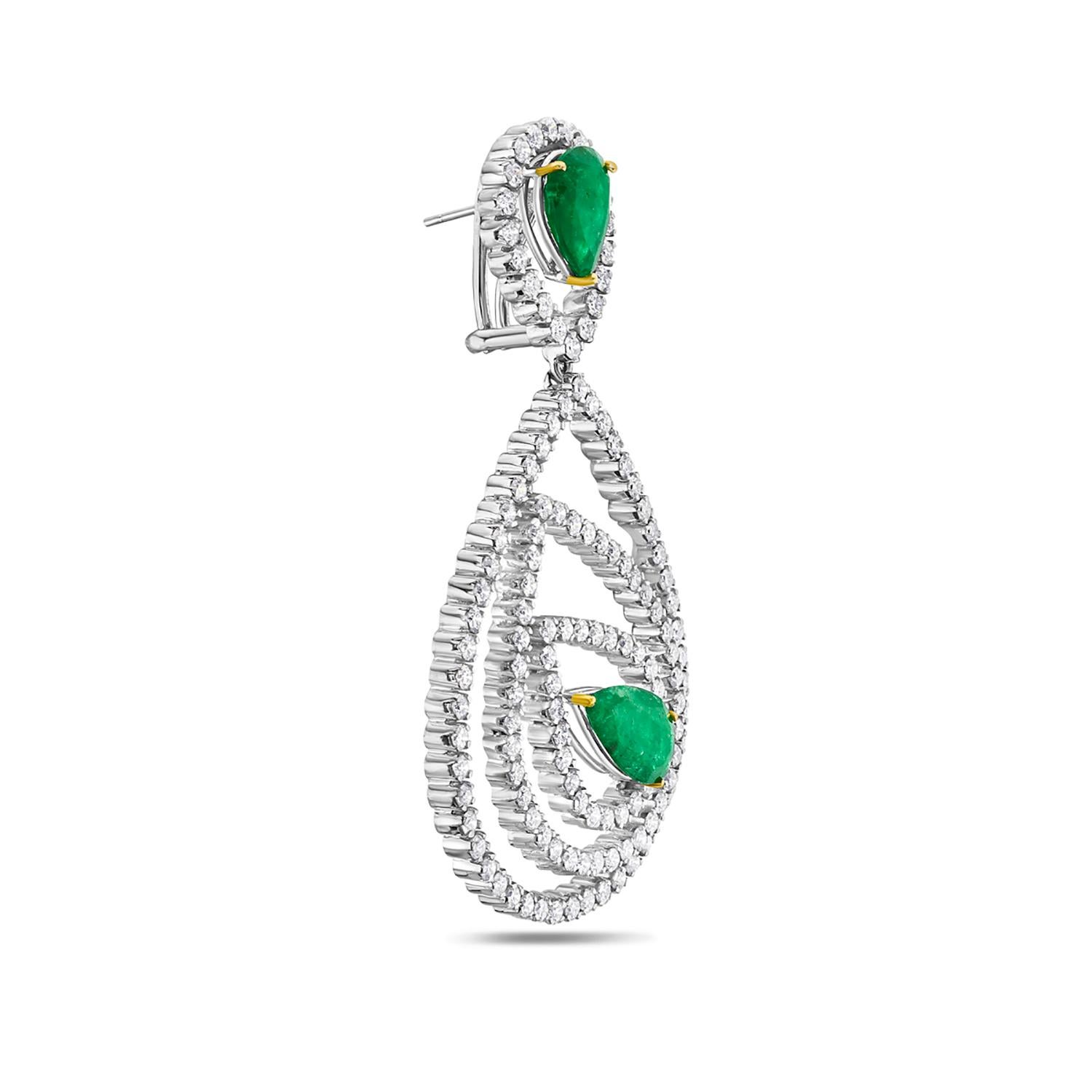 Enhance your jewelry collection with these breathtaking Pear-shaped Emerald Earrings caged in sparkling diamonds set in 18K white gold. Perfect for any special occasion, this timeless design is sure to add sophistication to any outfit. Shop now and
