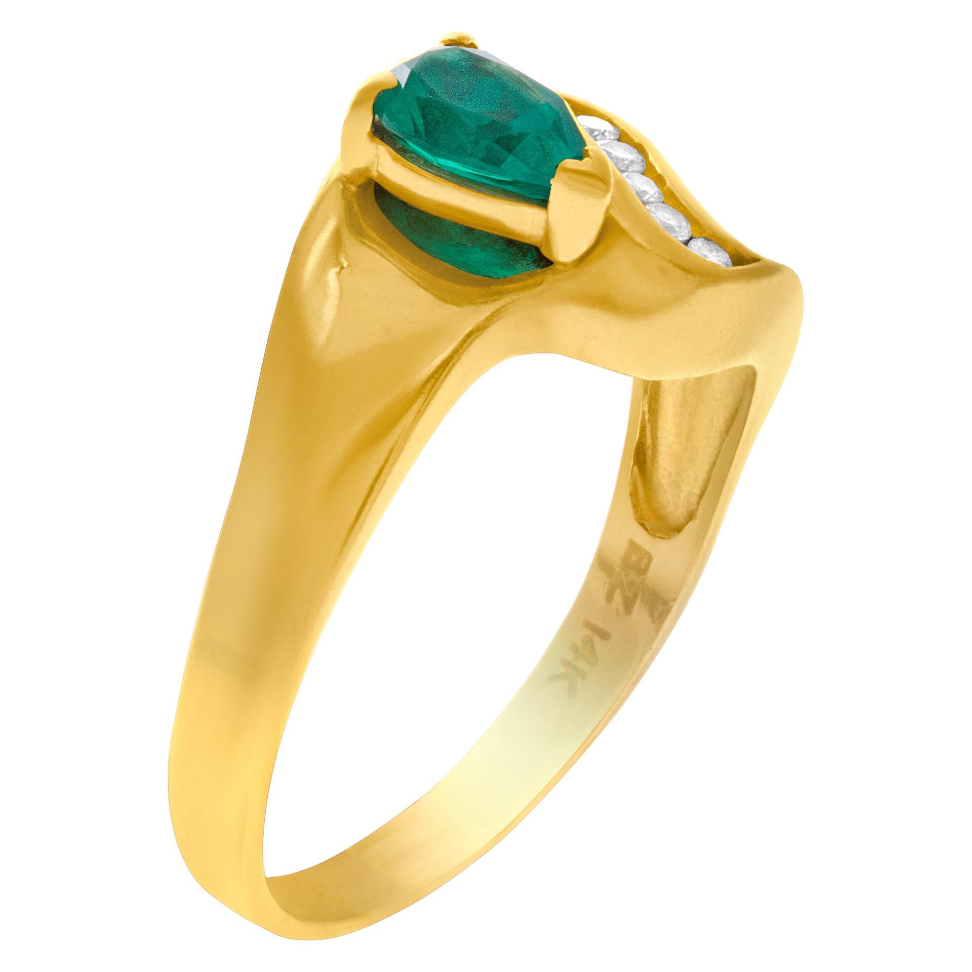 Danty pear cut emerald ring in 14k yellow gold with a swirl of diamond accents approx. 0.20 cts. Approximately 0.50 carat emerald. Width at the top is 12.7mm. Size is 10.

This Diamond/Emerald ring is currently size 10 and some items can be sized up