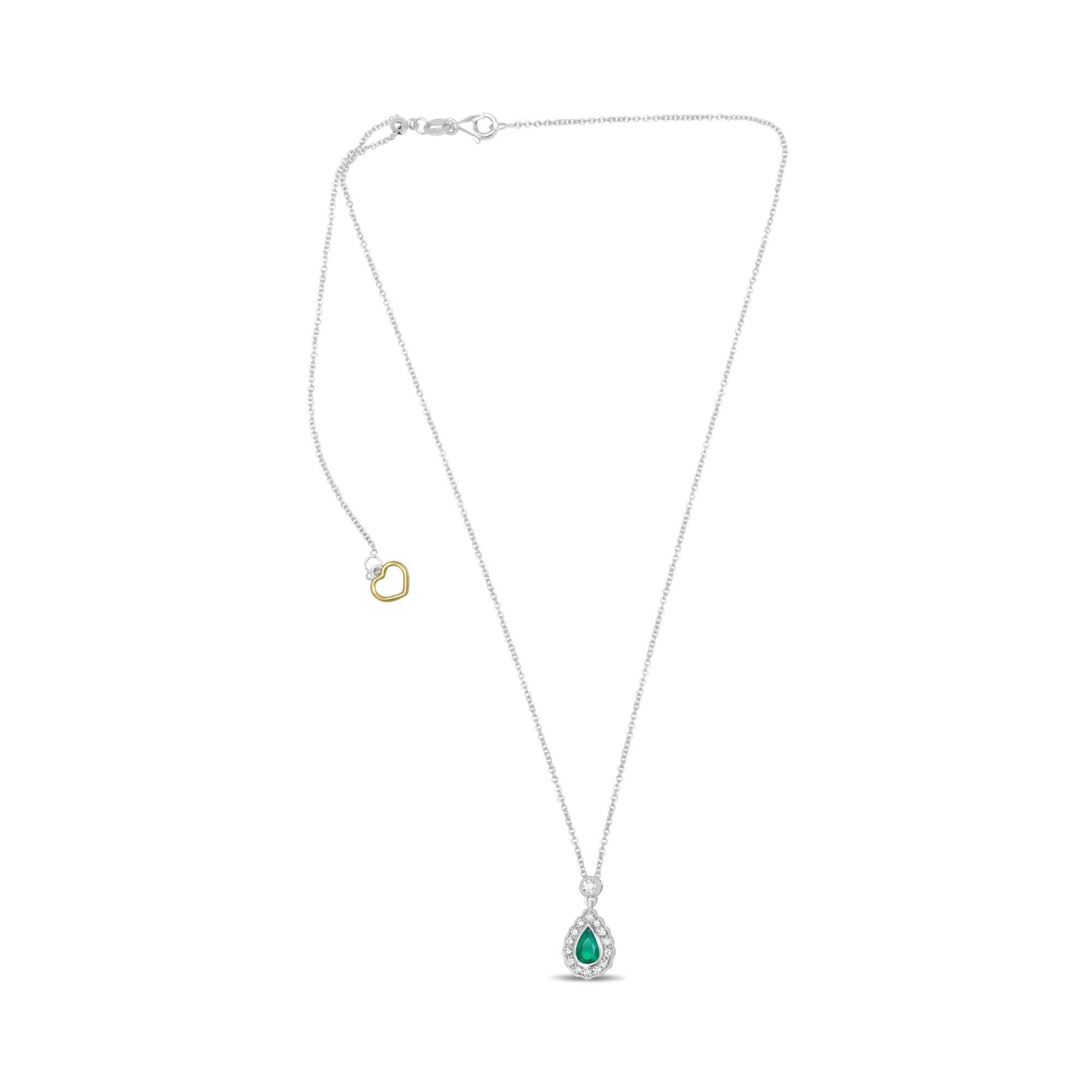 This 18 karat white gold necklace showcases a 0.58 carat, pear-shaped eye clean emerald accented by 0.25 carats of round cut white diamonds showcased in a stunning single halo ornamented by milgrain detailing. 

The luminous center stone sits in a